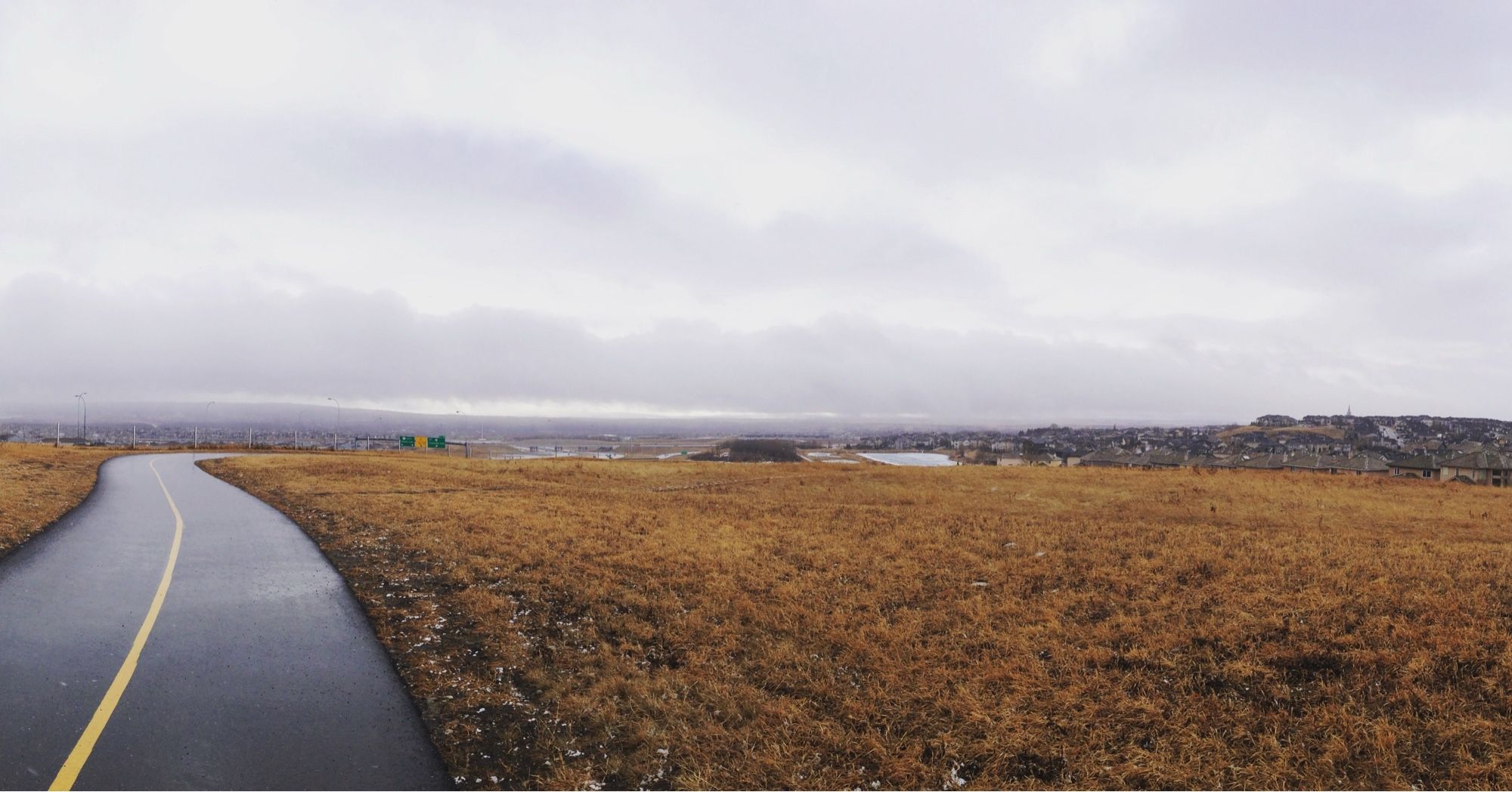 a cycling and walking path meanders through a prairie expanse