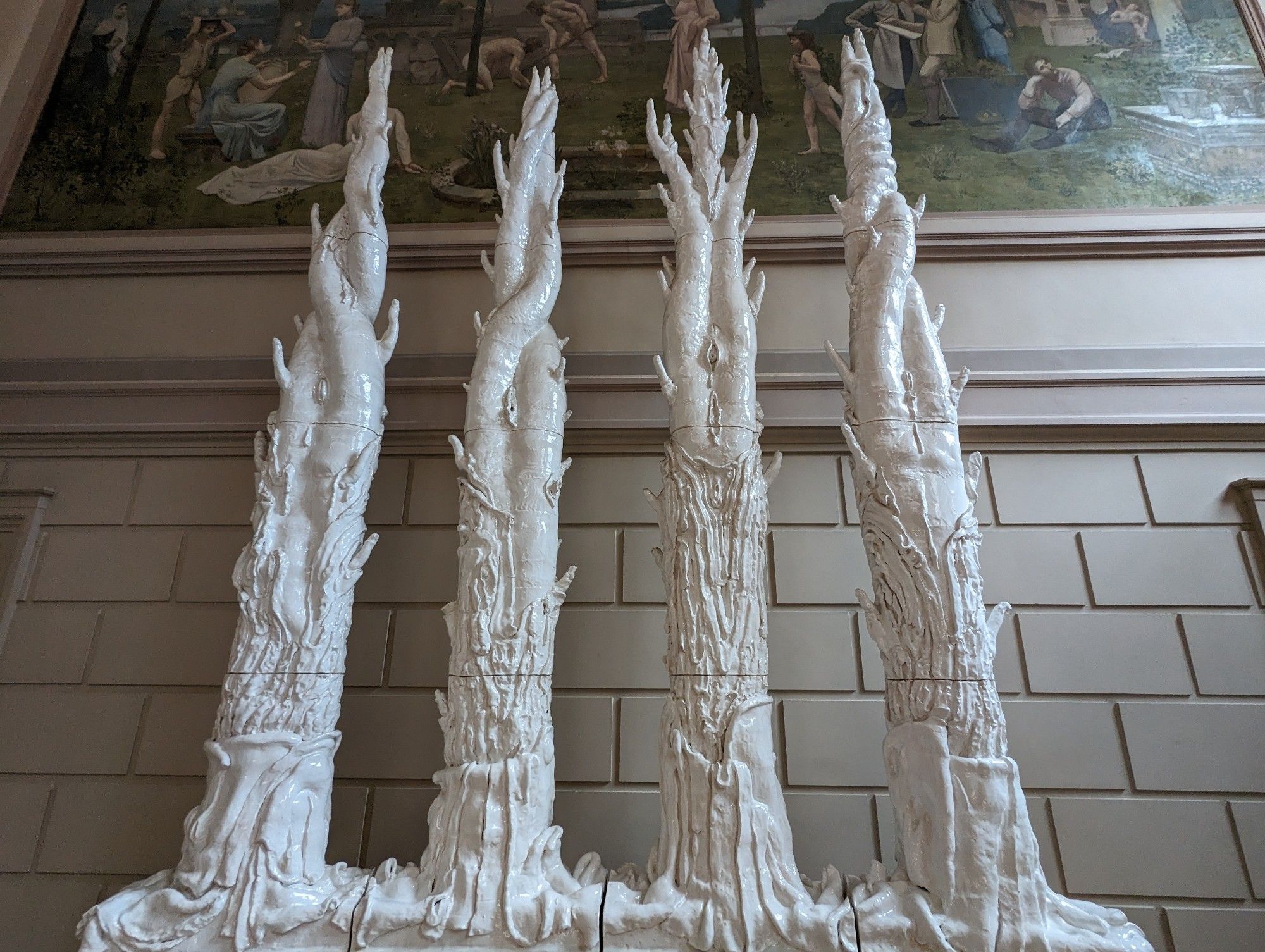 Photographs of a sculpture in the Rouen museum of fine art. The 4 pairs of twisted glistening tree-like communs appear as though layers have been peeled off, exposing various phallic and yonic details. The sculpture is described as representing the Heliades.