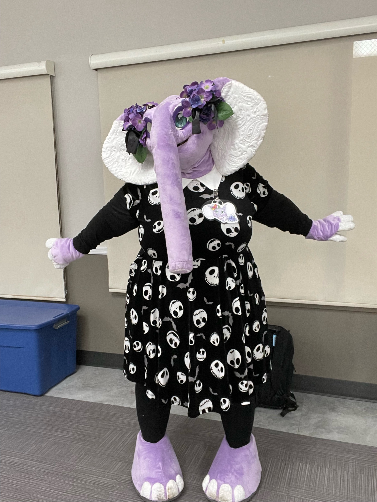 Lavender the purple elephant in a black dress with jack skellington faces, in a sassy pose