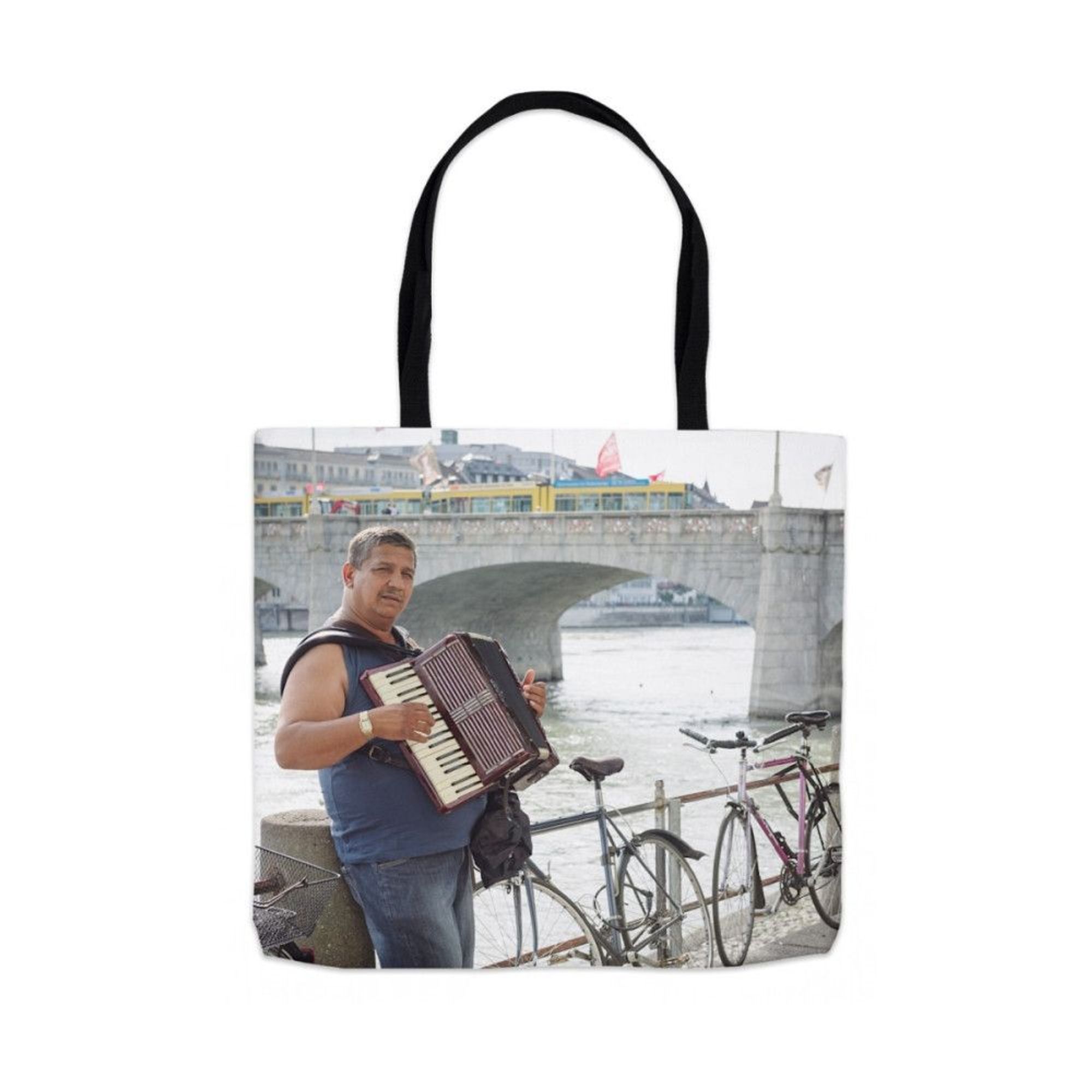 Totebag of a musician playing in Kleinbasel, Switzerland, looking over the Rhine River to the Altstadt of Basel, Switzerland