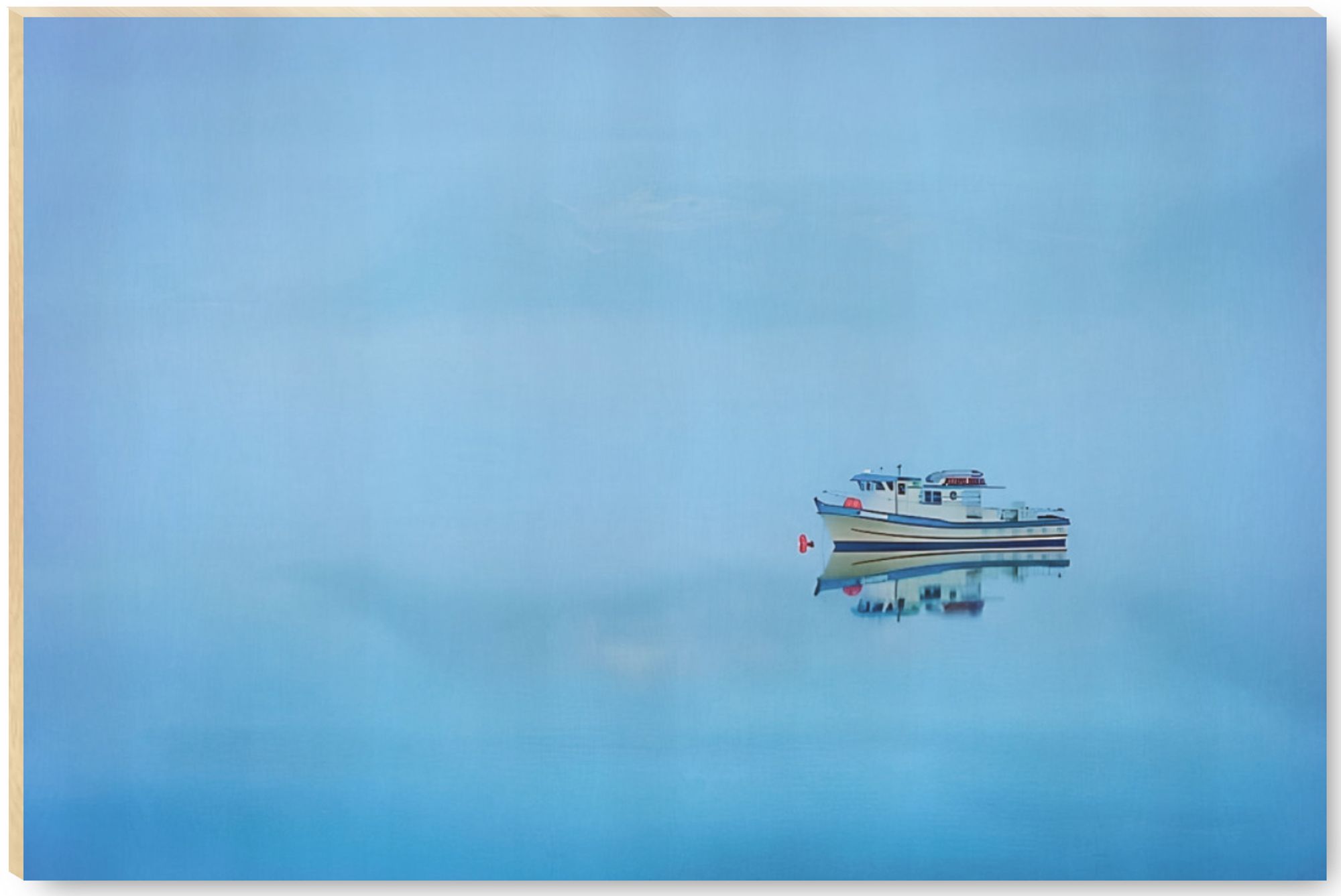 An Alaskan fishing boat floats into mist on still water