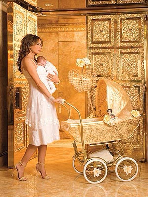 A photograph of melania trump holding a small baby, with a hand on a pram made of gold, in a golden room