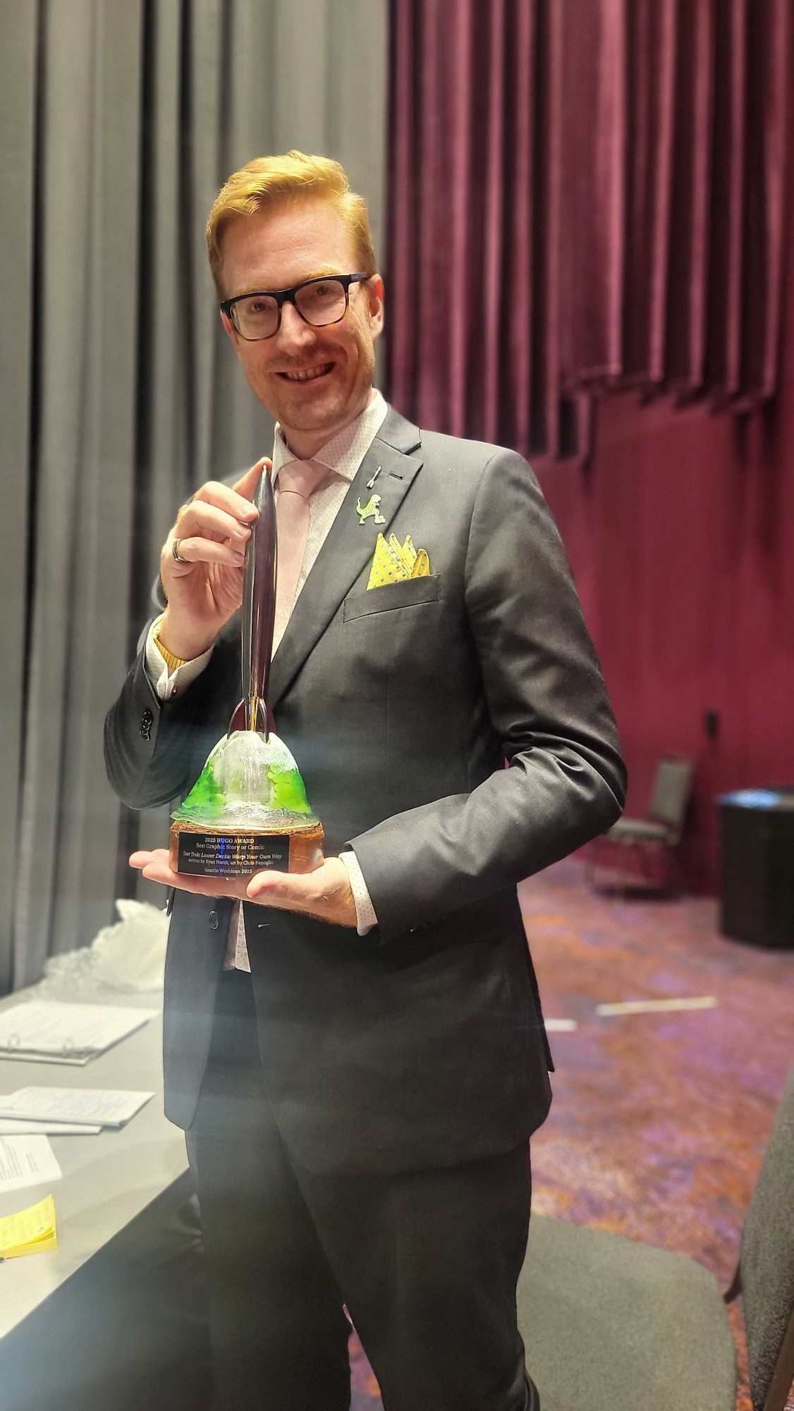 me holding the Hugo backstage.  I wore my T-Rex pin because YOU NEVER FORGET YOUR ROOTS (clipart webcomic where the pictures never change, it's better than it sounds)