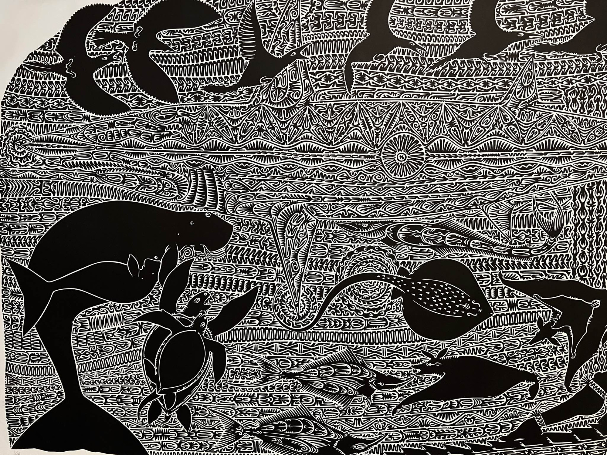 Intricate black and white images of rays, turtles, dugong, bats, birds and fishes, including background images picked out by traditional Torres Strait patterns