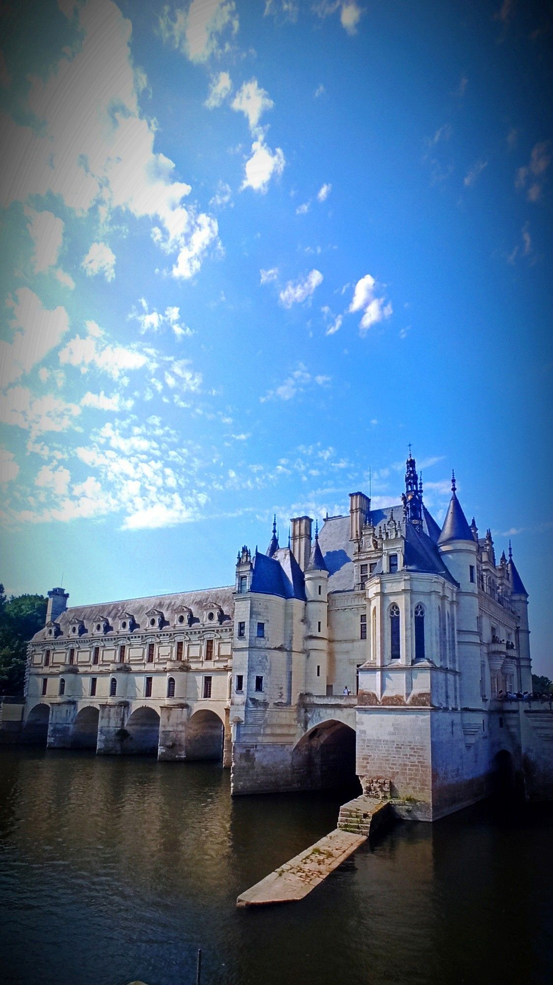 Château de Chenonceau. Le ciel est bleu avec des nuages blancs sur la partie gauche