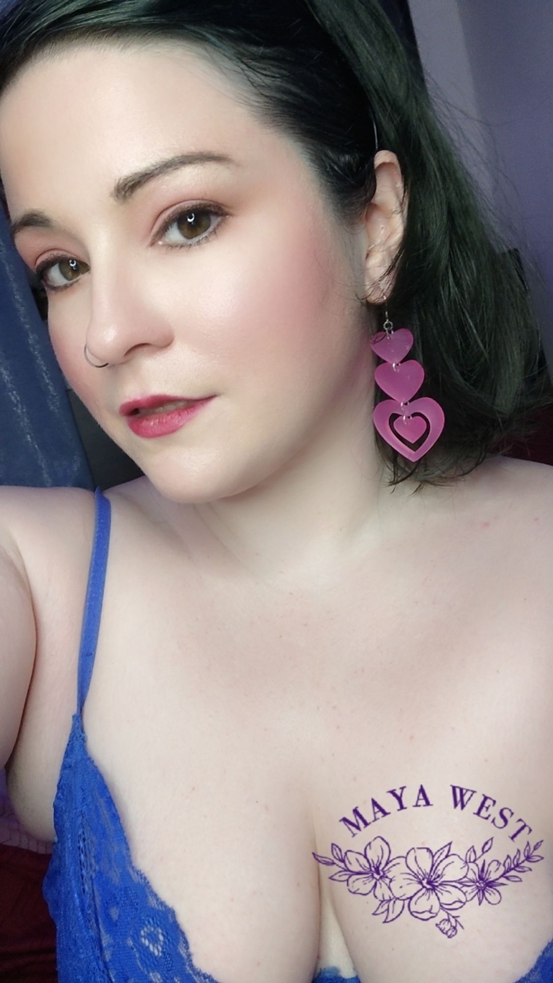 selfie of a pale femme with simple makeup and pink heart chandelier earrings.

🖤🧡🖤
#bbw 
#milf