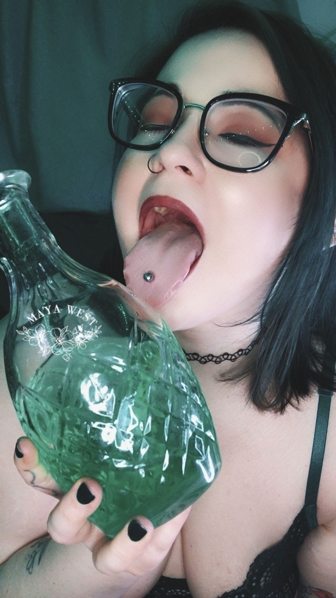 a curvy pale femme in elf ears and black glasses licking a bottle half full of green liquid.

🖤🧡🖤
#halloween
#samhain 
#bbw 
#milf
#pierced
#alt
#footsky
#paypig