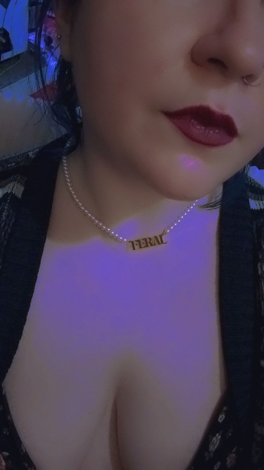 lower face selfie of a pale femme in a comfy black sweater and a pearl necklace that reads "feral". theyre in a dark room and their hair is pulled back

🖤🧡🖤