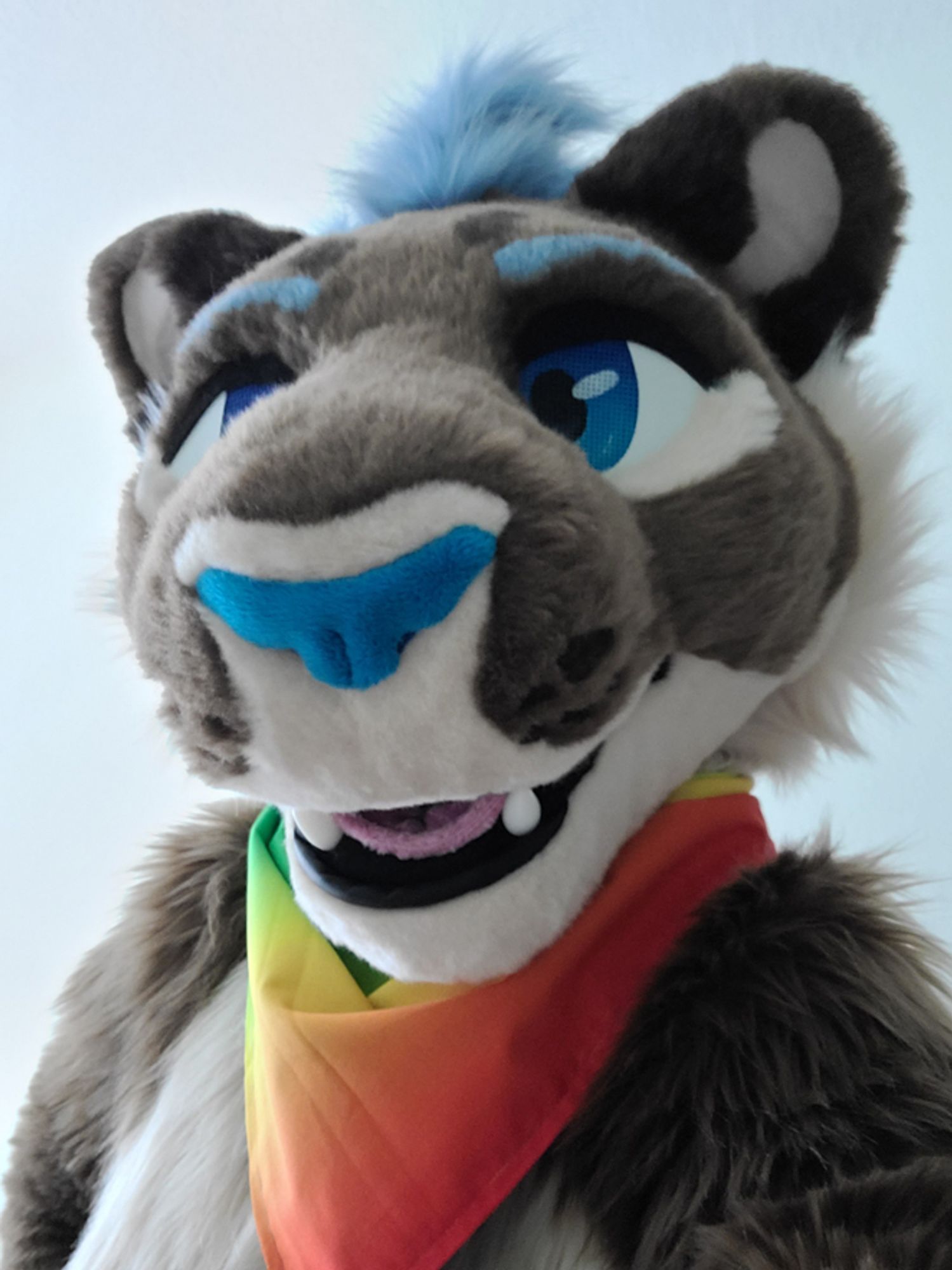 Lioness fursuiter wearing rainbow bandana