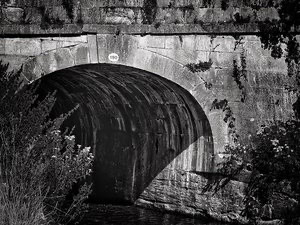 Black-and-white photo of a canal tunnel in Bath