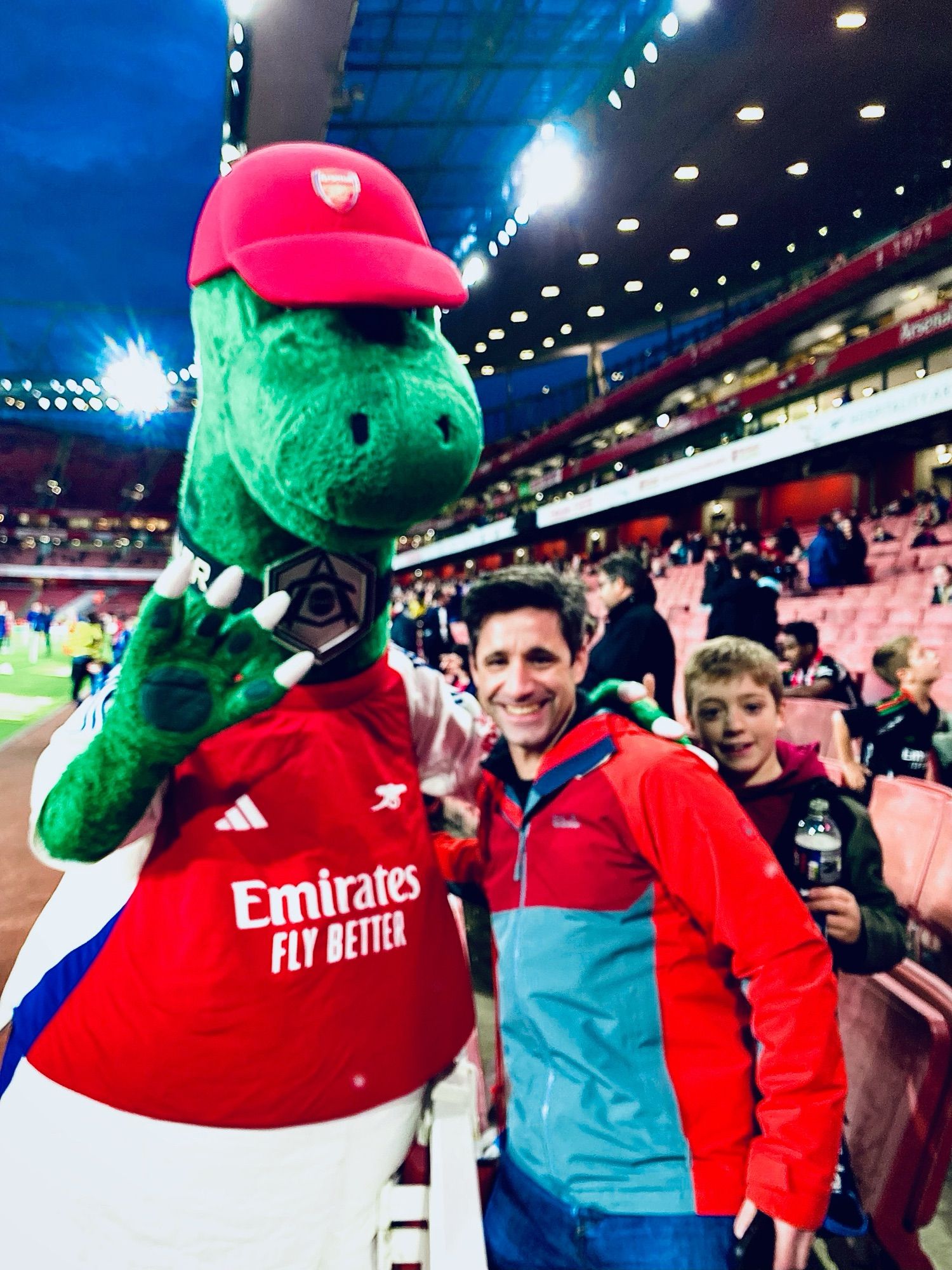 Picture of an over-excited middle-aged academic standing next to Gunnersaurus, mascot of Arsenal FC.