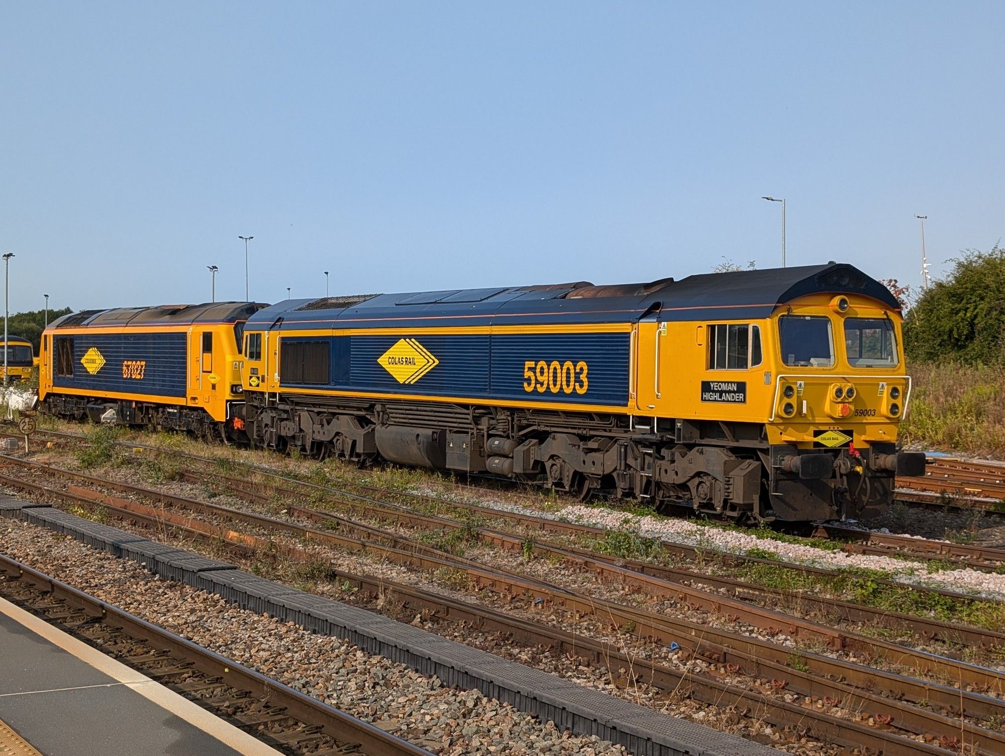 Class 59 number 59003 and class 67 67027 stabled at Westbury, both wearing GBRF blue and orange paint but with yellow Colas Rail decals