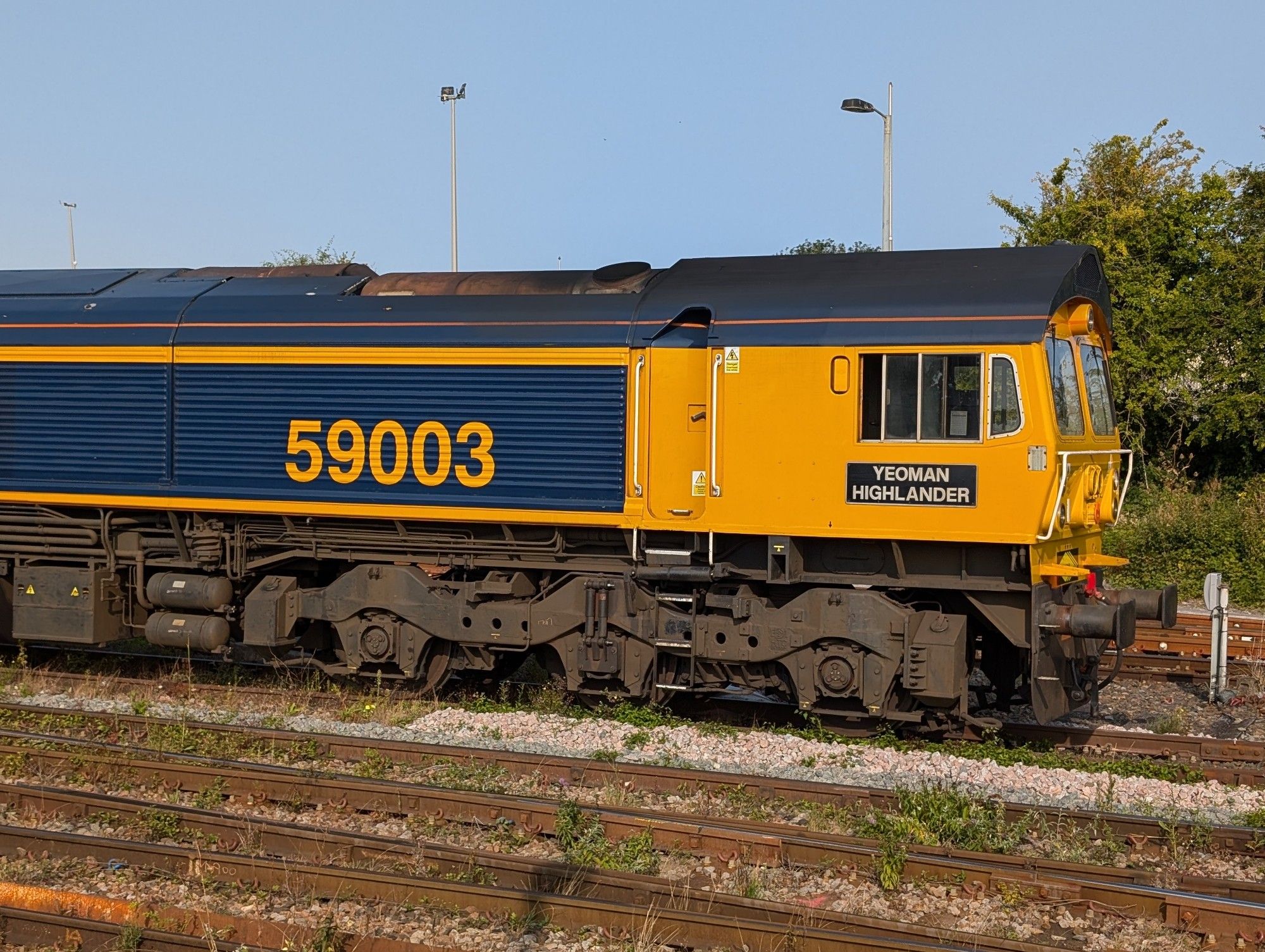 Class 59 number 59003 cab and body side shot in its blue and orange paint with it's "Yeoman Highlander" nameplate in view