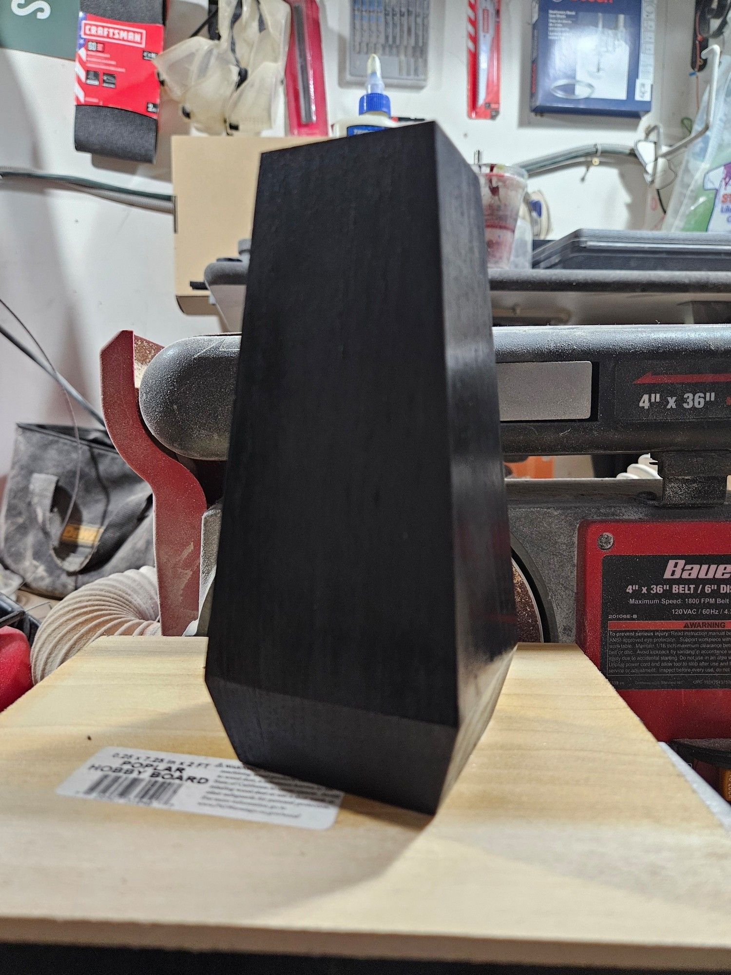 Red oak obelisk, 6" tall by 3" square.
Painted glossy black, awaiting drilling with 0.5 mm for displaying "threadless" body jewelry ends