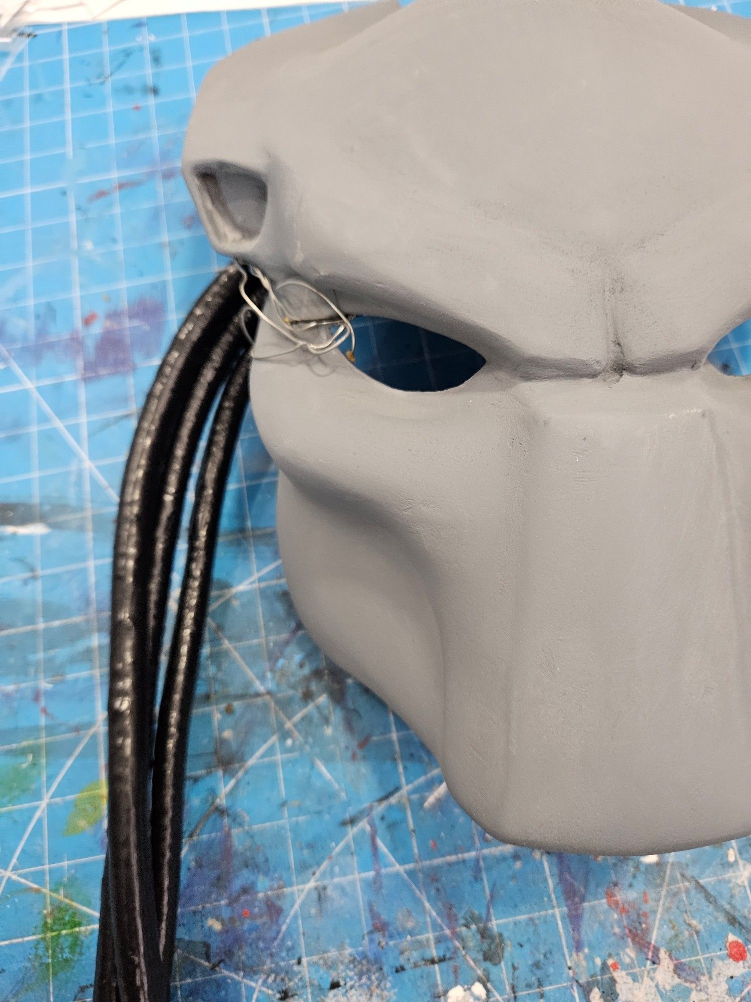 3d printed predator mask with a sample of home crafted "hair" black and tubular