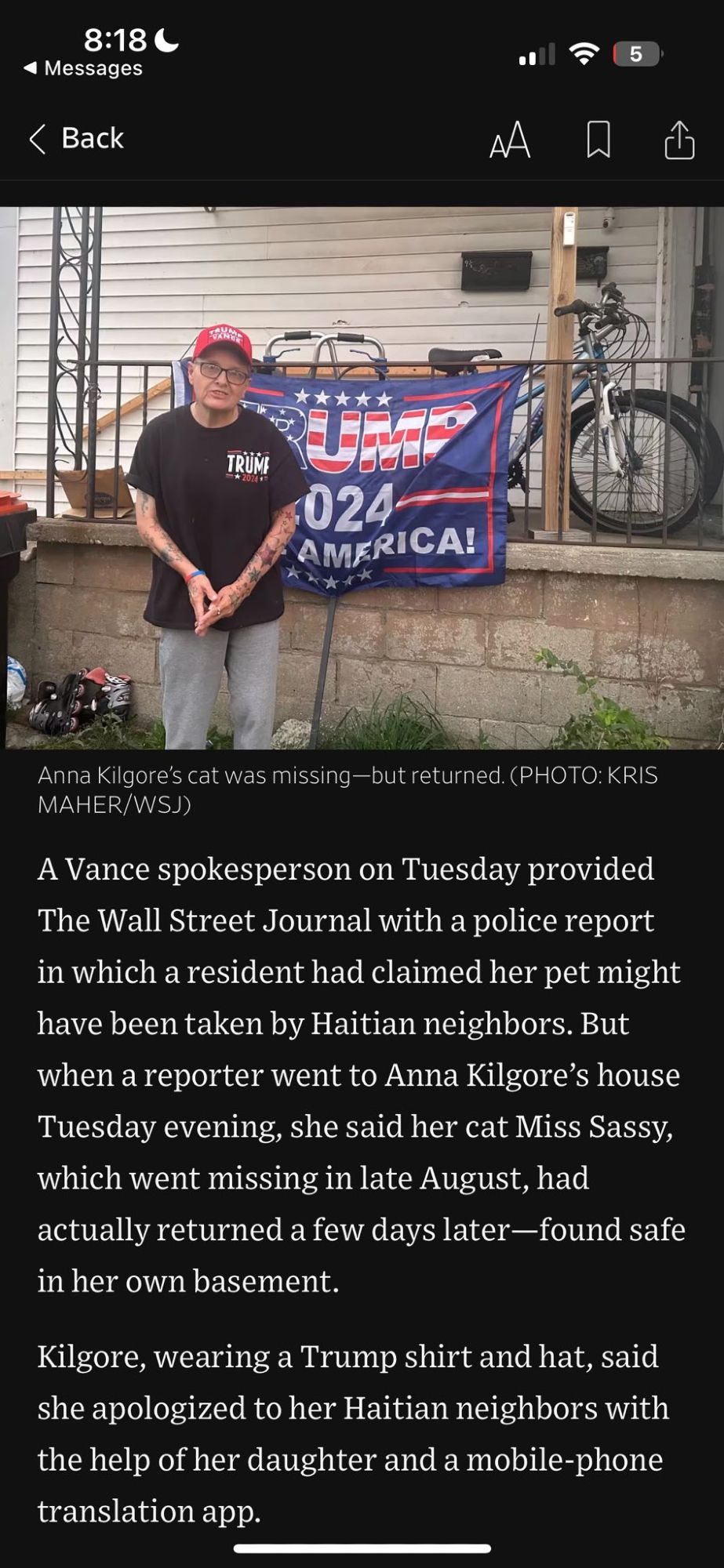 Wall Street Journal article. Photo at the top shows Anna Kilgore in front of her house, with Trump 2024 sign hanging. The caption says "Anna Kilgore's cat was missing—but returned." The text underneath says "A Vance spokesperson on Tuesday provided the Wall Street Journal with a police report in which a resident had claimed that her pet might have been taken by Haitian neighbors. But when a reporter went to Anna Kilgore's house Tuesday evening, she said her cat Miss Sassy, which went missing in late August, had actually returned a few days later—found safe in her basement. Kilgore, wearing a Trump shirt and hat, said she apologized to her Haitian neighbors with the help of her daughter and a mobile-phone translation app.