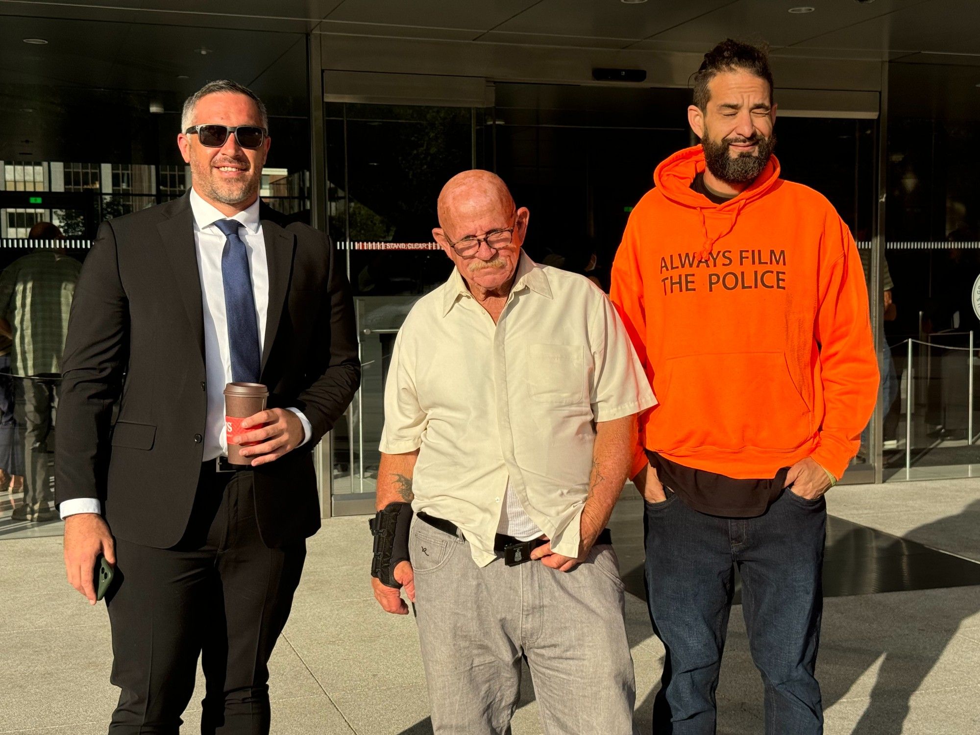 Photo of 3 veterans who are part of the Powers v. McDonough class action lawsuit in front of the court house on August 6, 2024.