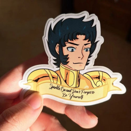 Sticker of a bust of Capricon Shura with a ribbon under him saying Sparkle on and don't forget to be yourself