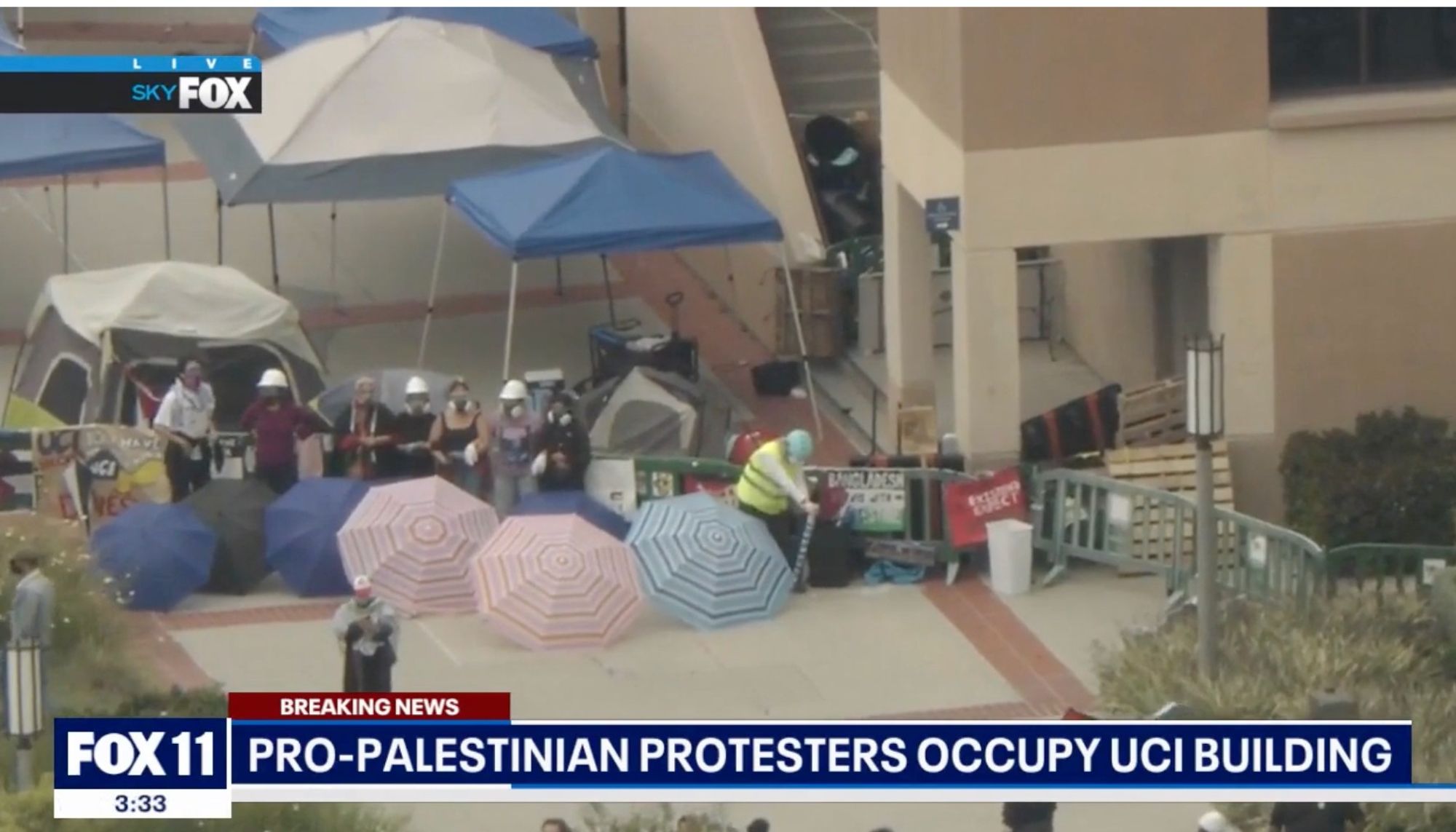 screenshot of Fox 11 (LA)

tight aerial shot

building with some people and beach umbrellas in front.