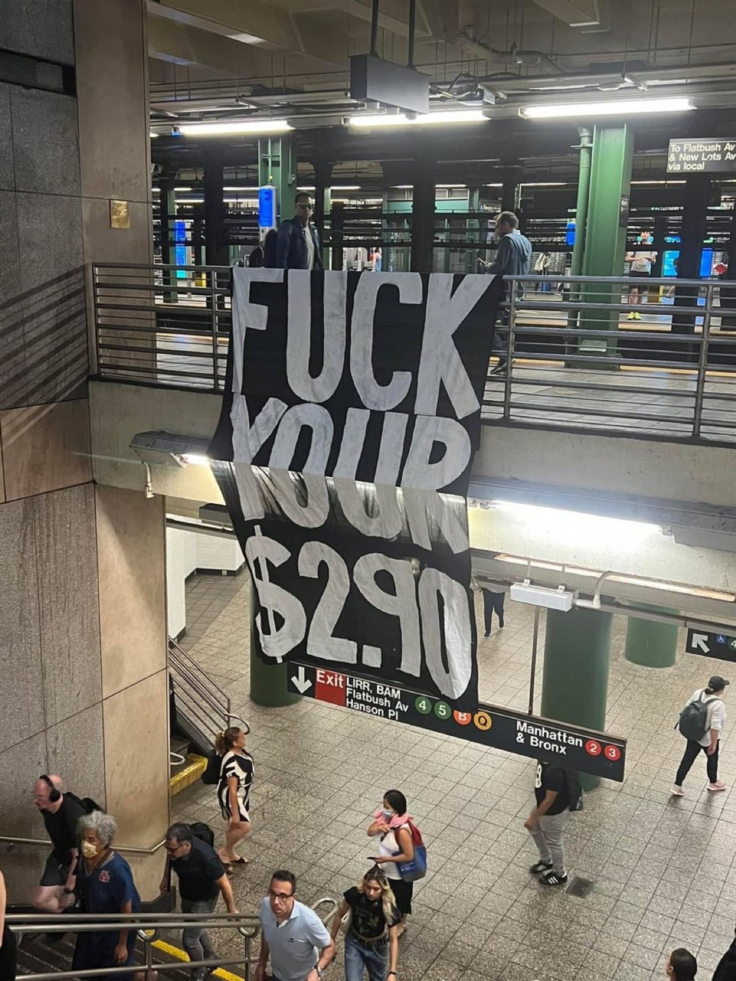 in a subway station drapped from one level to the other a very large black banner painted in white:

FUCK
YOUR
$2.90

People walk by going about their business. Because it's New York City.