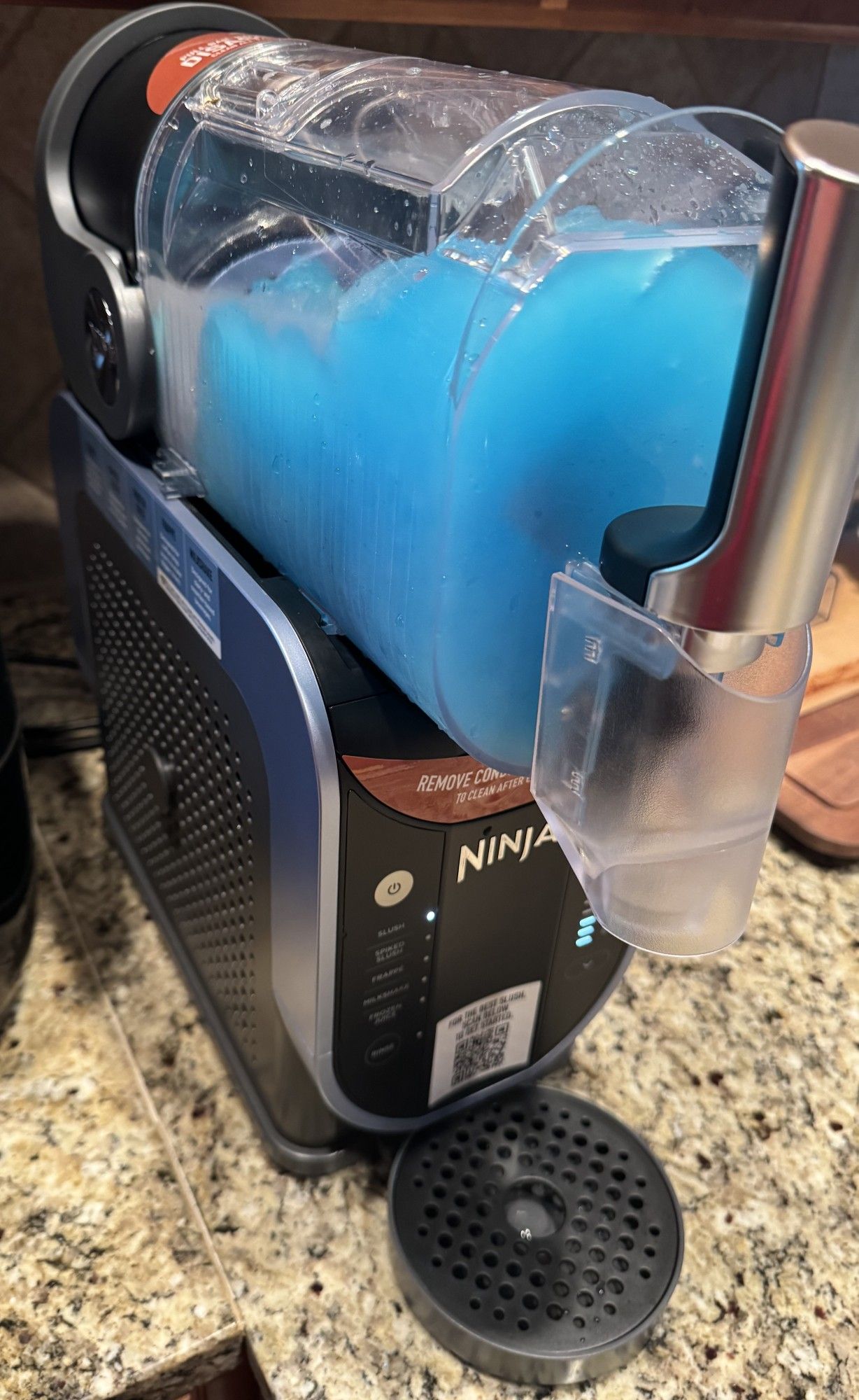 A Ninja Slushi, a cold beverage maker by the Ninja company, making a slush drink from blue raspberry flavored Powerade