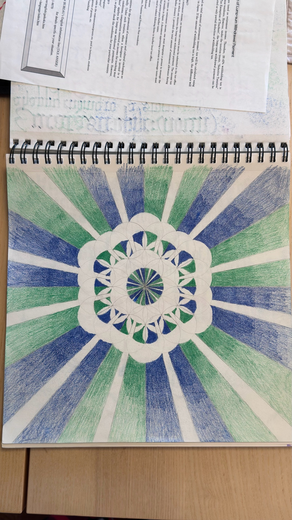 A flower of life colored in green and blue