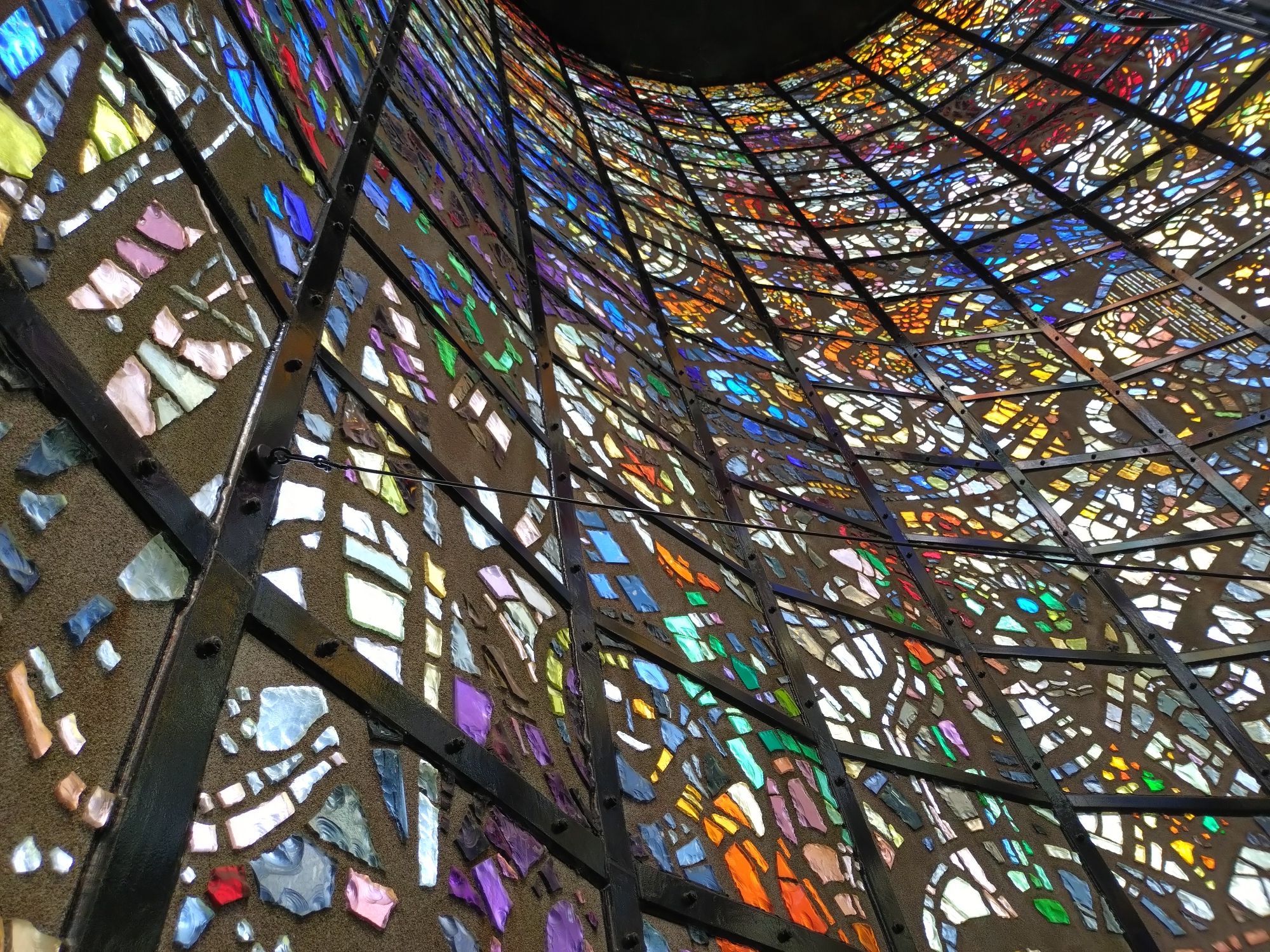 A tall wall made of exquisite and intricate stained glasses