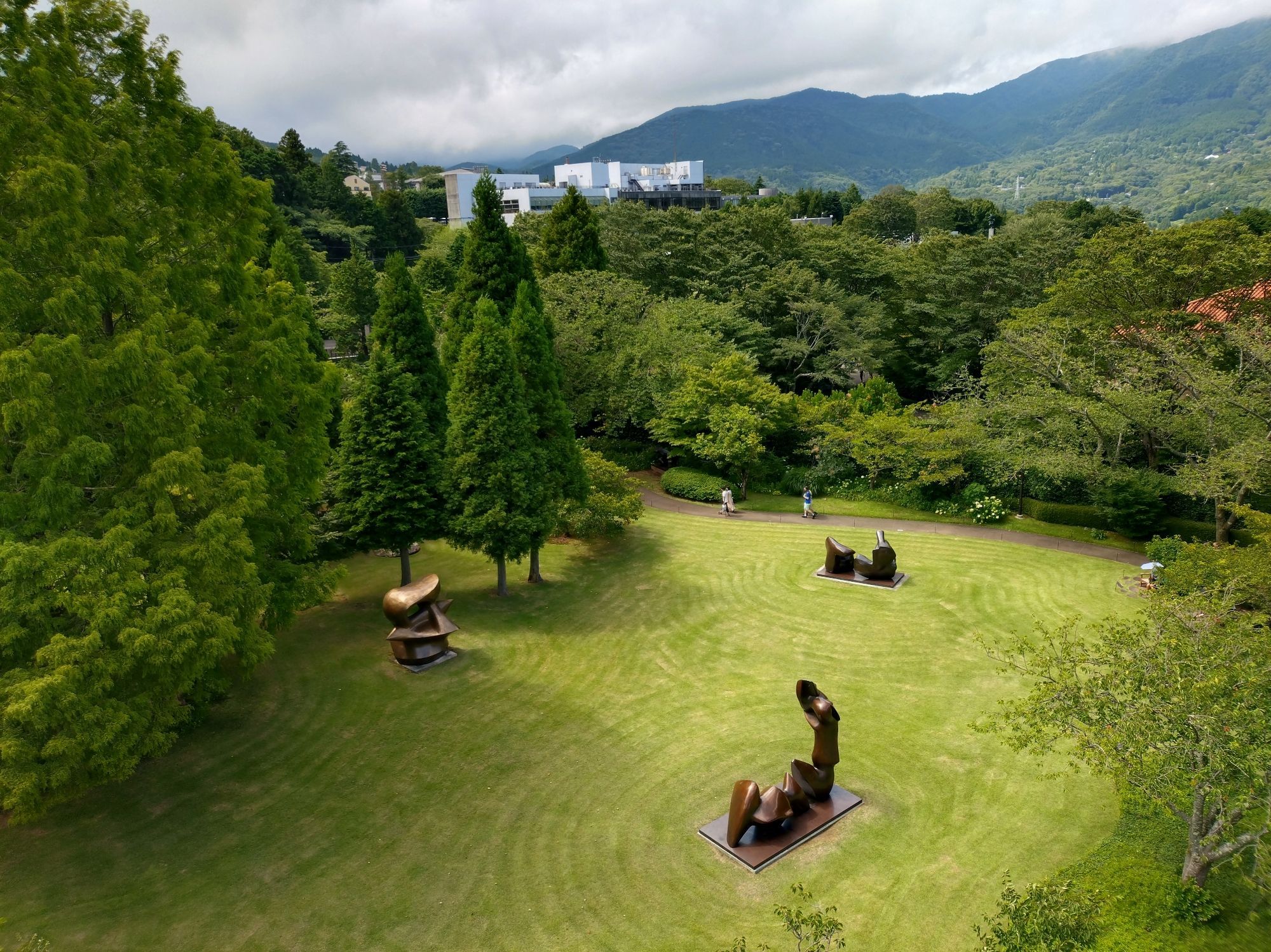 A view a green with some Henry Moore sculptures, which is a part of the open-air musiam