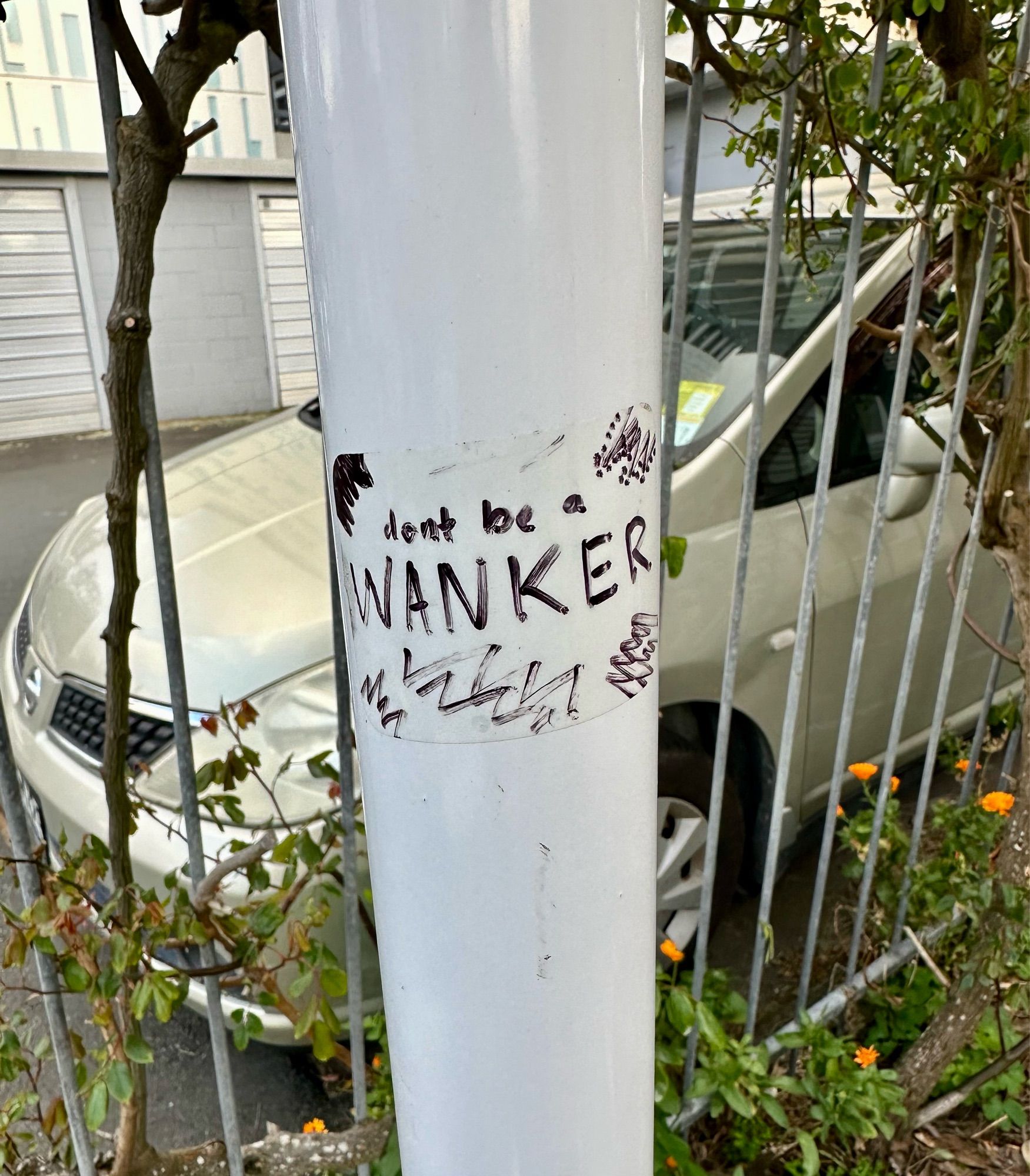 sticker on post- don’t be a wanker