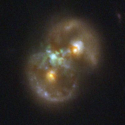 Two galaxies colliding to form what looks like an infinity symbol, with a green haze of gas in the middle.

Credit: NASA, ESA, CSA, STScI, Pieter van Dokkum (Yale) 