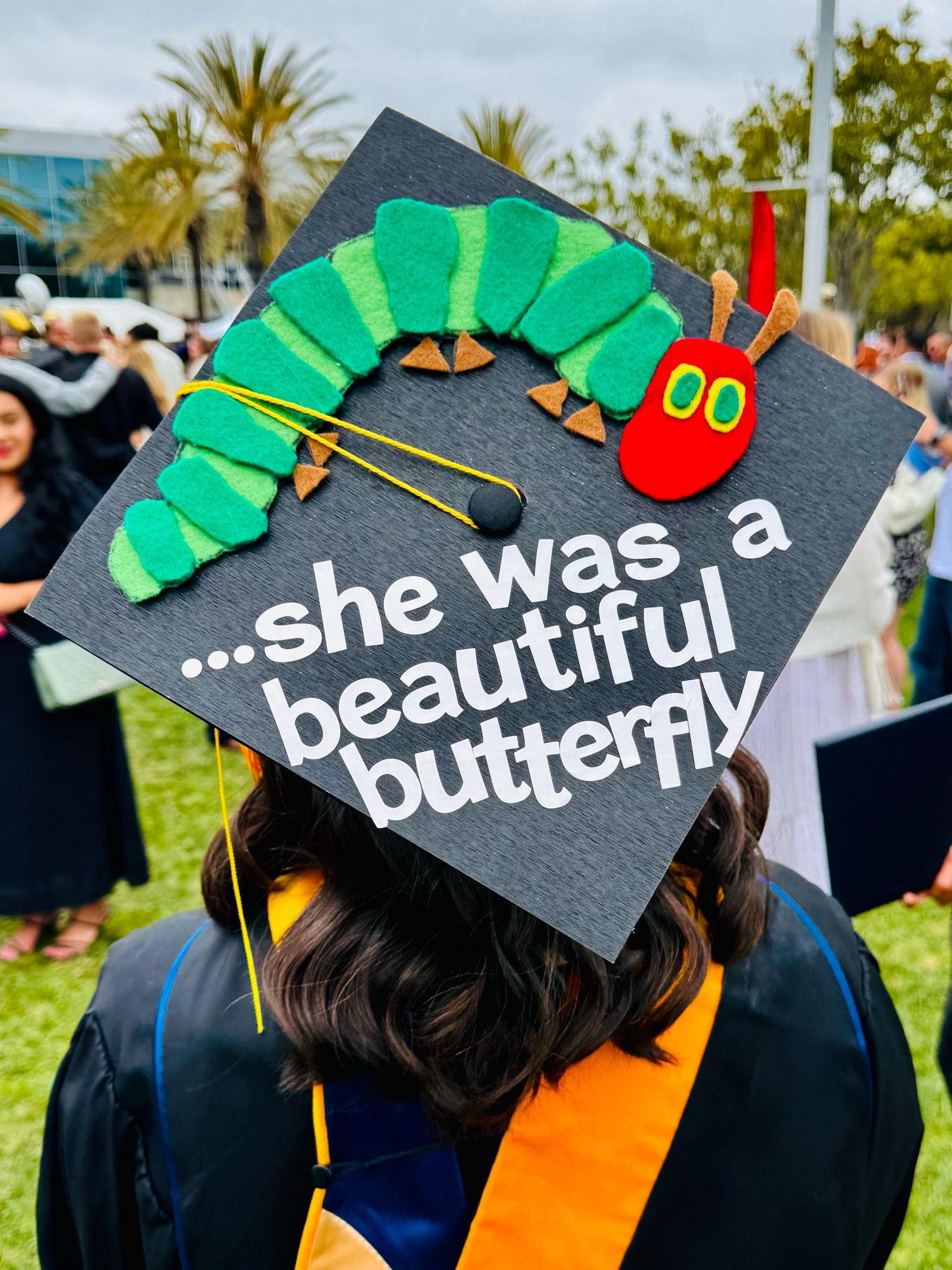 Graduation cap decorated with the hungry hungry caterpillar with the words “she was a beautiful butterfly”