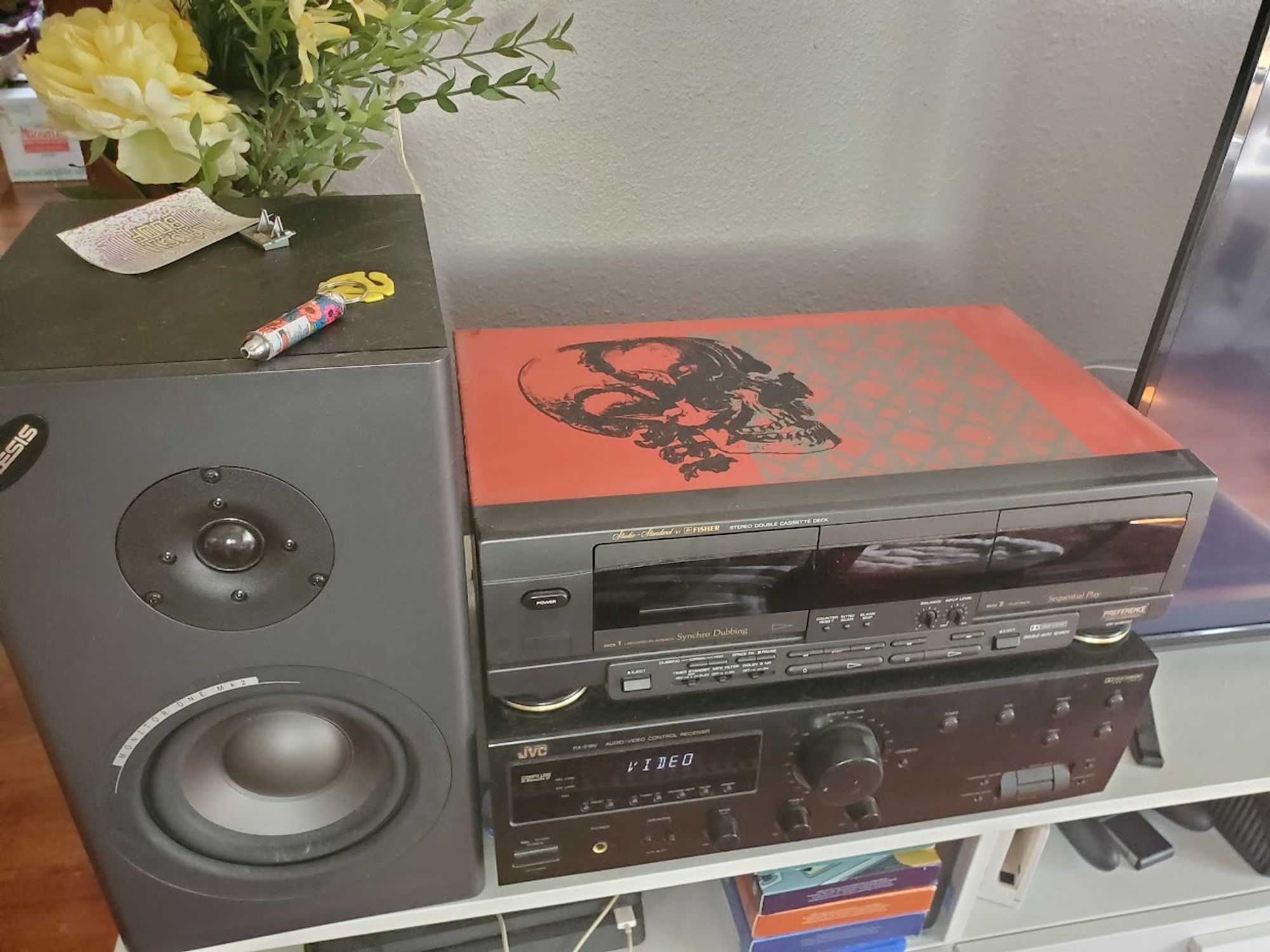 Tape deck where the top of the deck is entirely red, a black skull is printed on it, plus a gray pattern