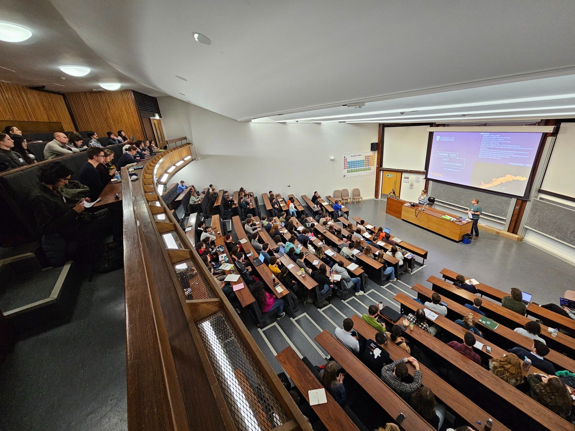 Photo of attendees at VMSG 2024 conference taken from the upper balcony, looking down over the rows of people sat watching a presentation