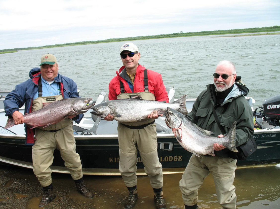 Samuel Alito, Paul Singer and another man hold large salmon they caught in Alaska.