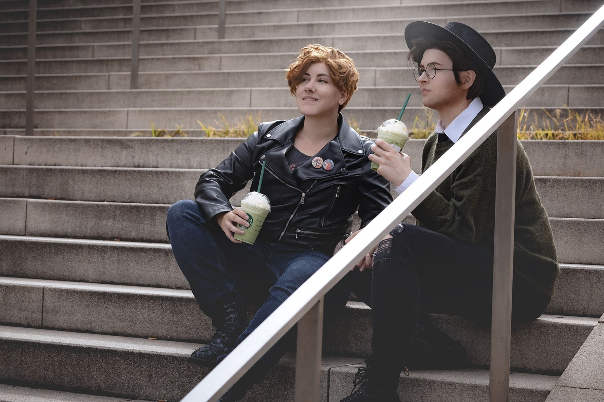 Gregg and Angus cosplayer sitting on stairs with a drink