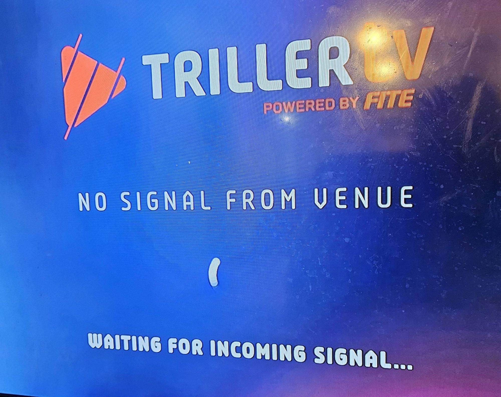 The Trillertv logo and a sign saying they are waiting for a signal from the venue.