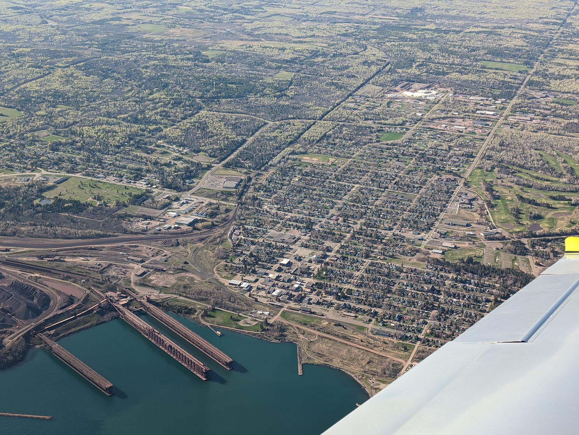 picture of a small town on a lake taken over the left wing of a small airplane