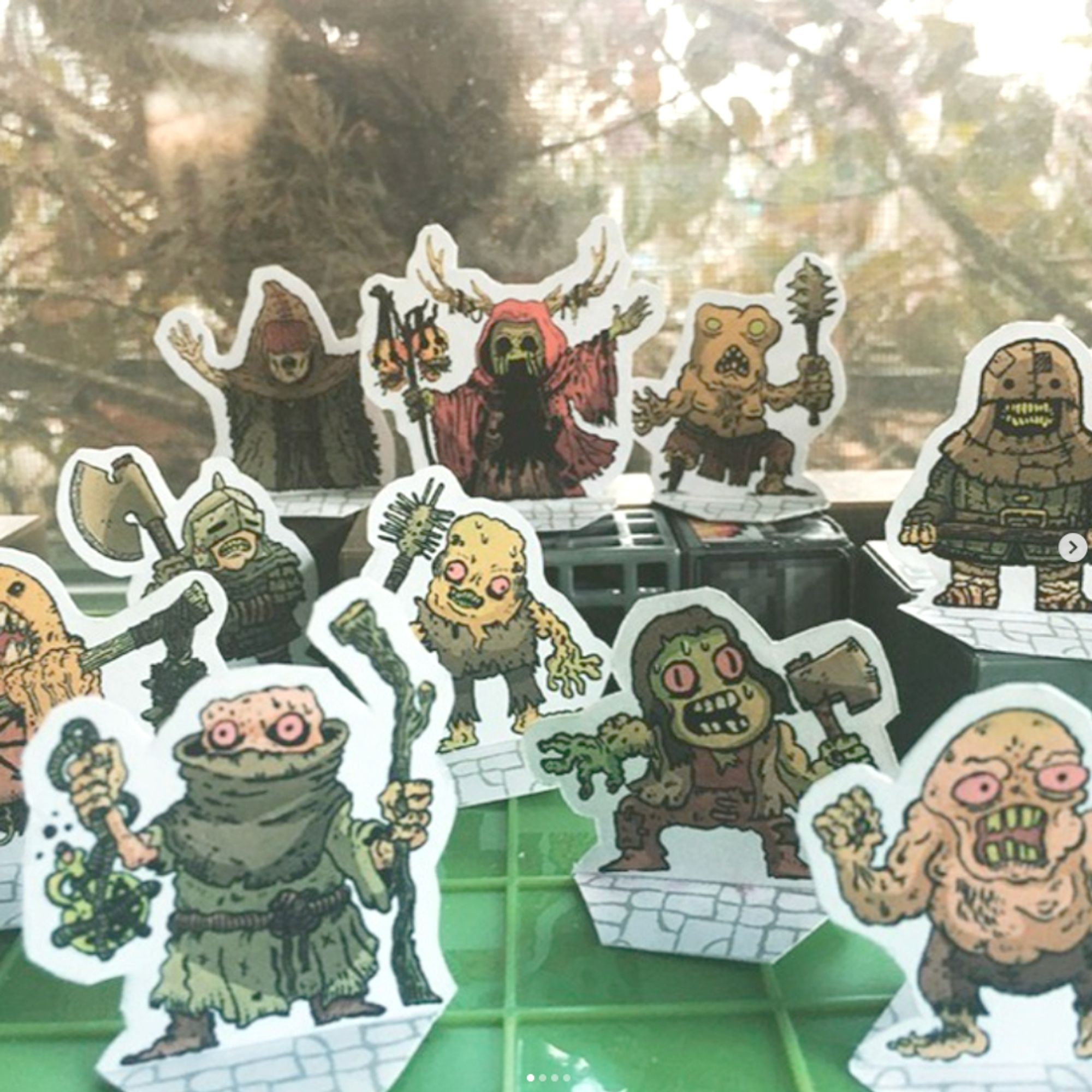 Paper miniatures of forest mutants and worshippers of evil forest gods.