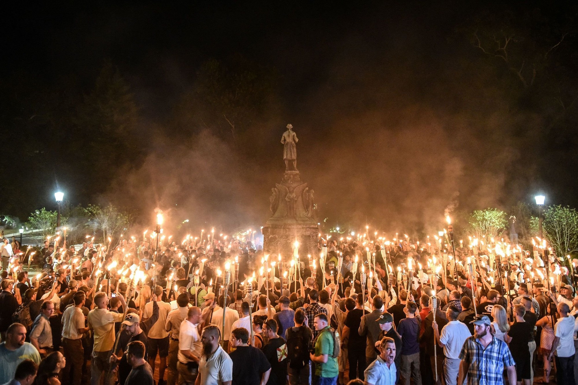 Hundreds of self-proclaimed white nationalists holding lit tiki torches gather around the statue of Thomas Jefferson in front of the Rotunda at the University of Virginia. August 11, 2017.