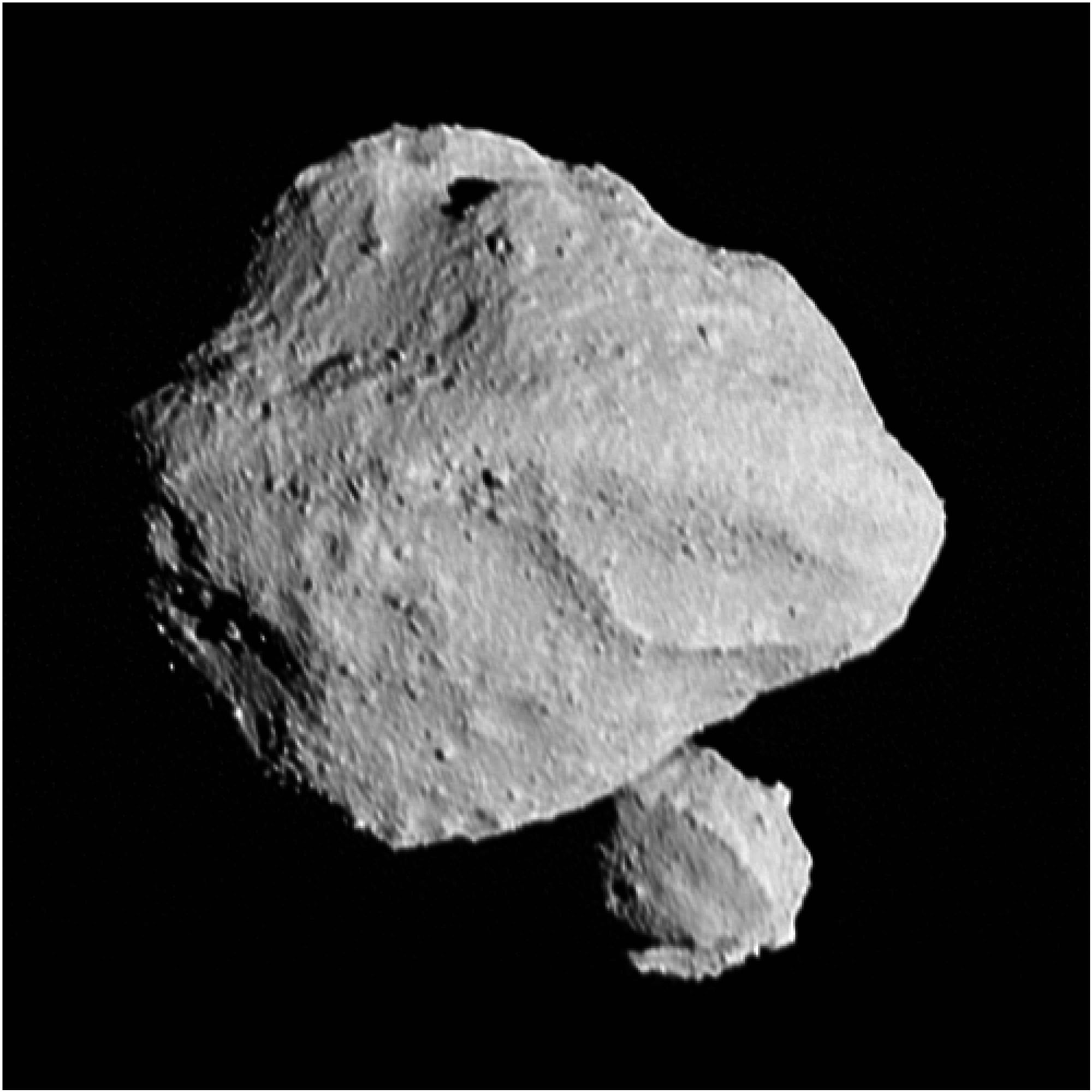 An image of asteroid Dinkinesh, a pair of grey asteroids with a slightly jagged surface, taken from the Lucy spacecraft. One of the asteroids is much larger than the other.