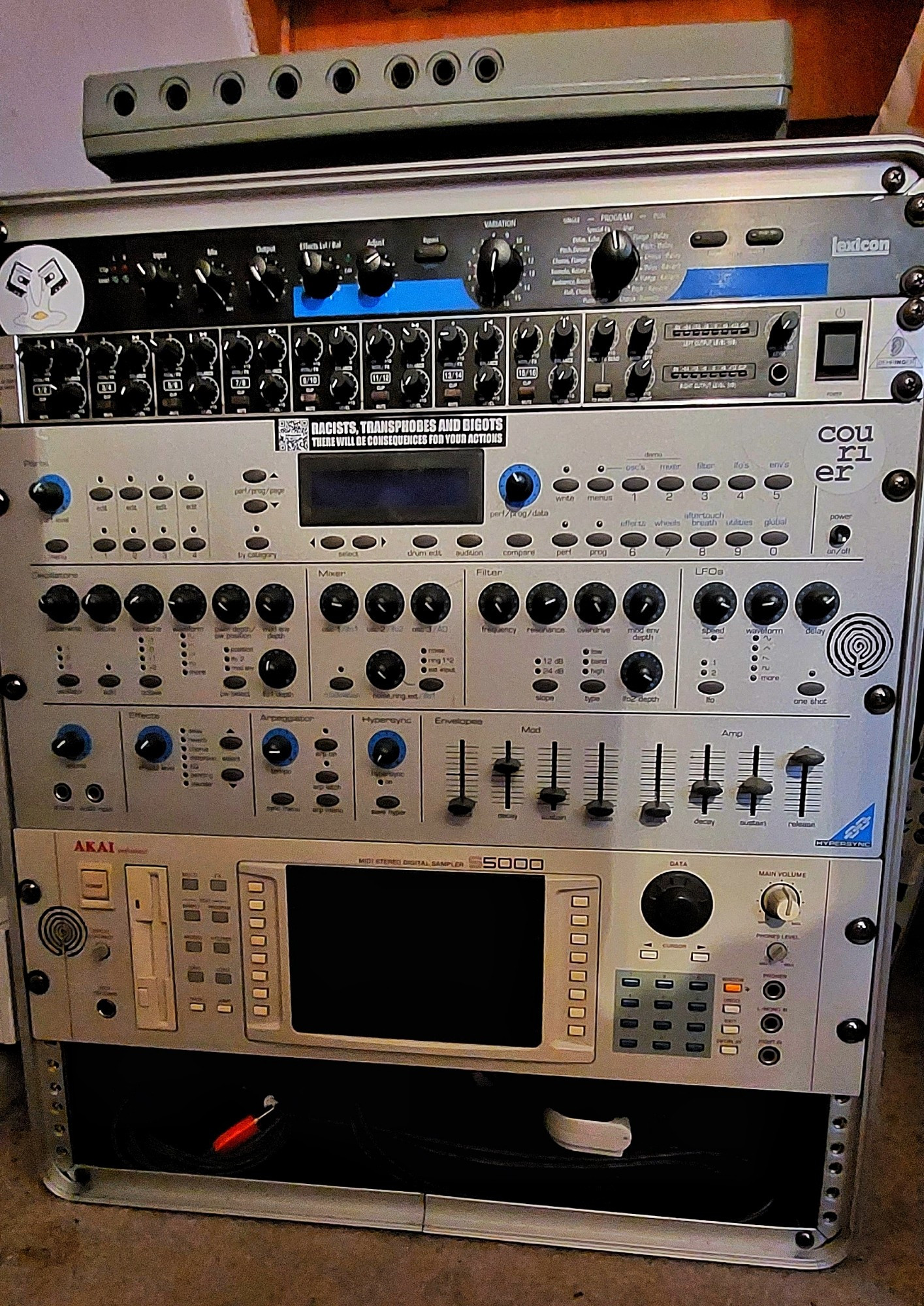 A 19inch rackmount case containing an Akai S5000 sampler, Novation KS synth, Behringer 8 channel mixer and a Lexicon FX unit.