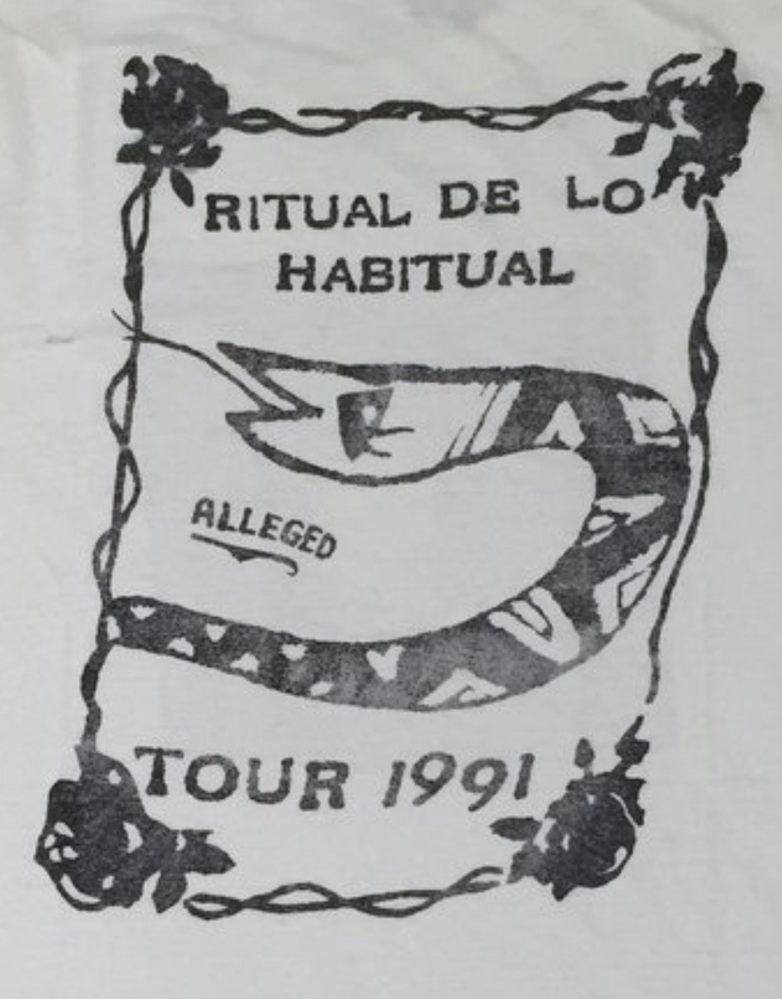 The Jane's Addiction alleged tour shirt. It says Ritual de lo Habitual (the album name) with a drawn-on snake and a viny rectangle border. The tshirt is white with black print.