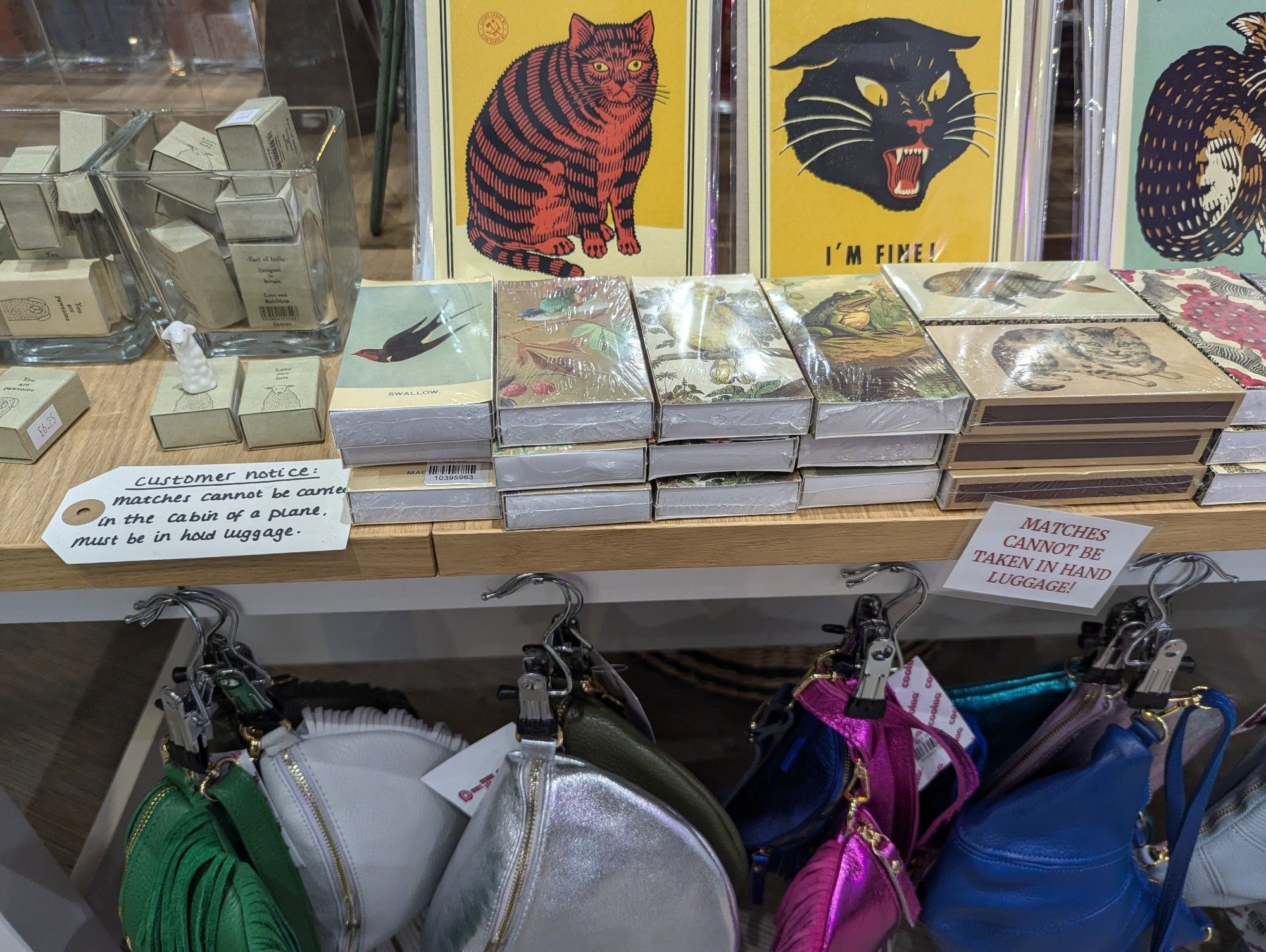 Fancy matchboxes for sale in a shop with a label that says "Match boxes £2.75 each (cannot be taken in hand luggage)"