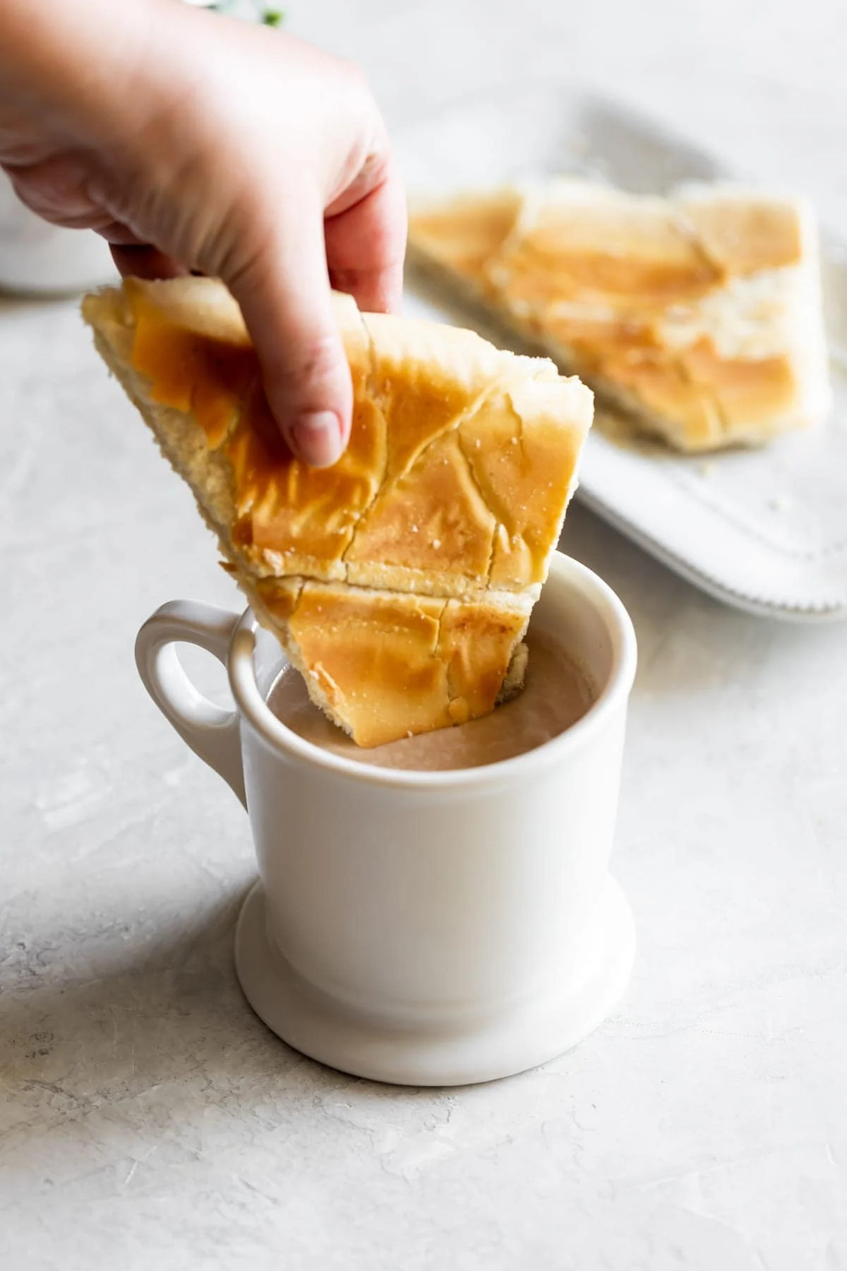 cuban toast being dipped in cafe con leche