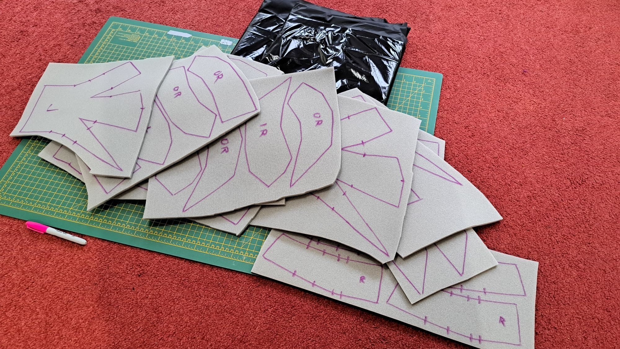 Several pieces of 6mm scrim foam with pattern pieces traced onto them