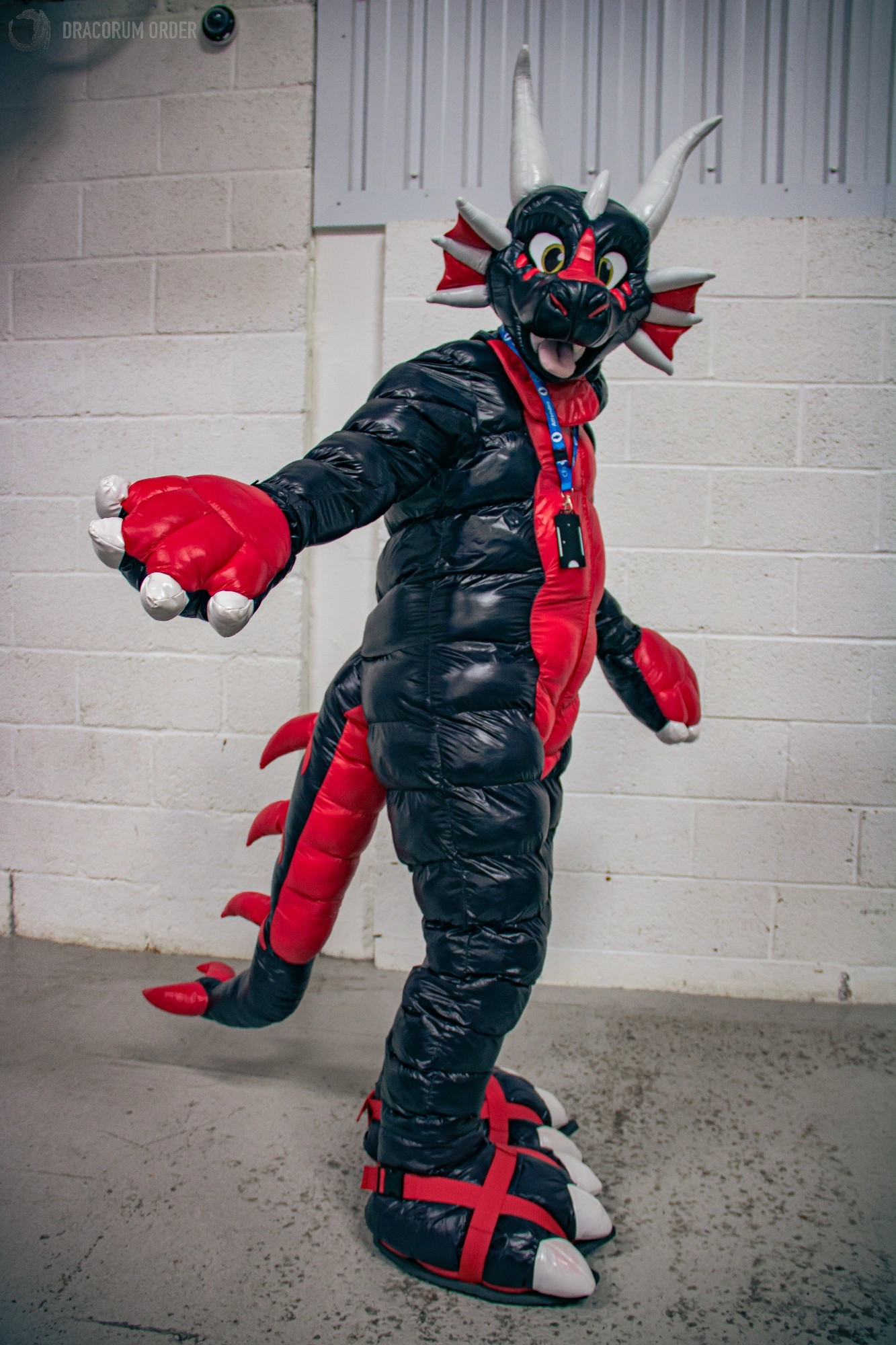 NyFi, the shiny nylon dragon suit. Made of red and black nylon fabric, with padded body, big soft feetpaws, and padded plush hand mitts.