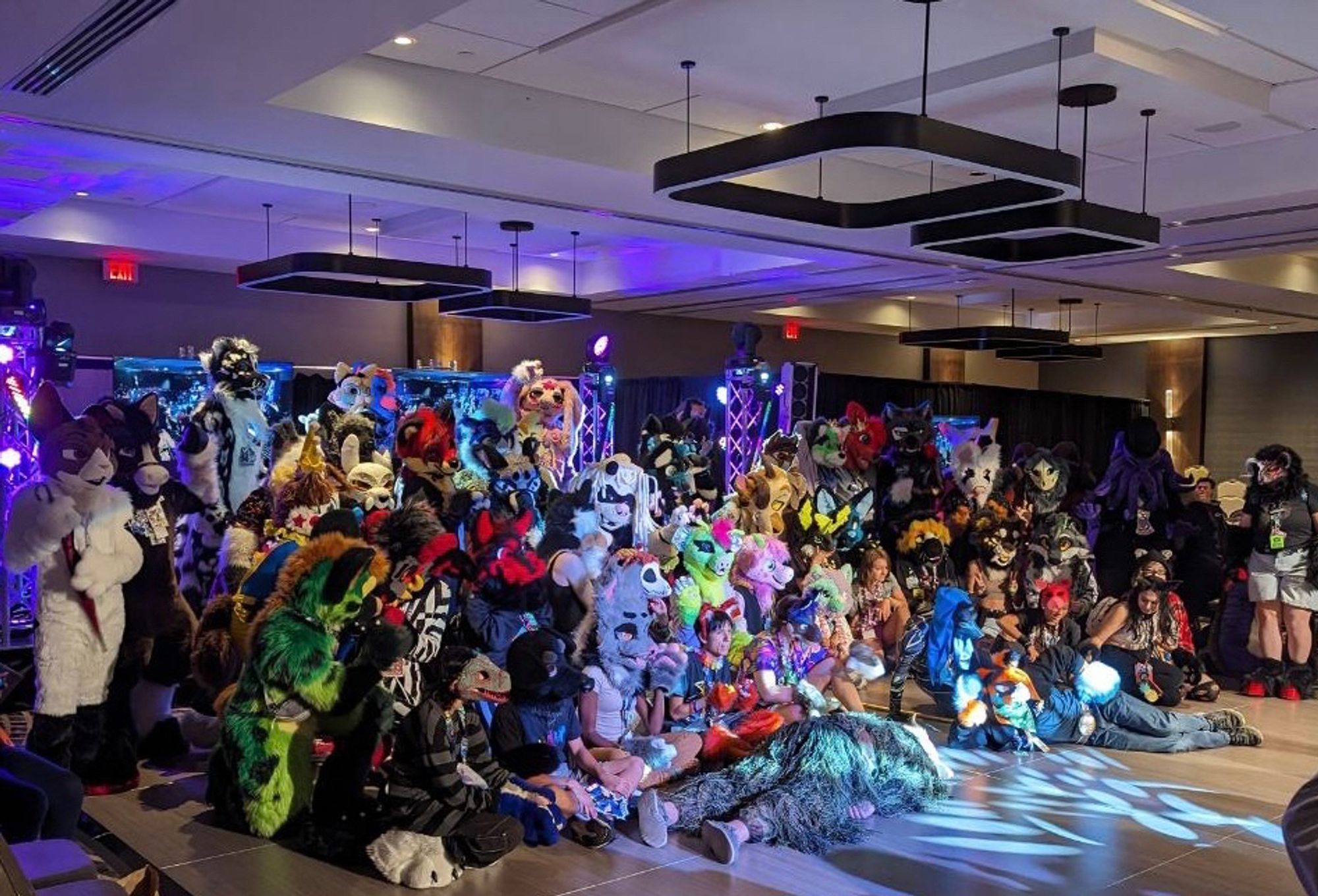 Participants and con goers posing for a group picture after the Fursuit Runway