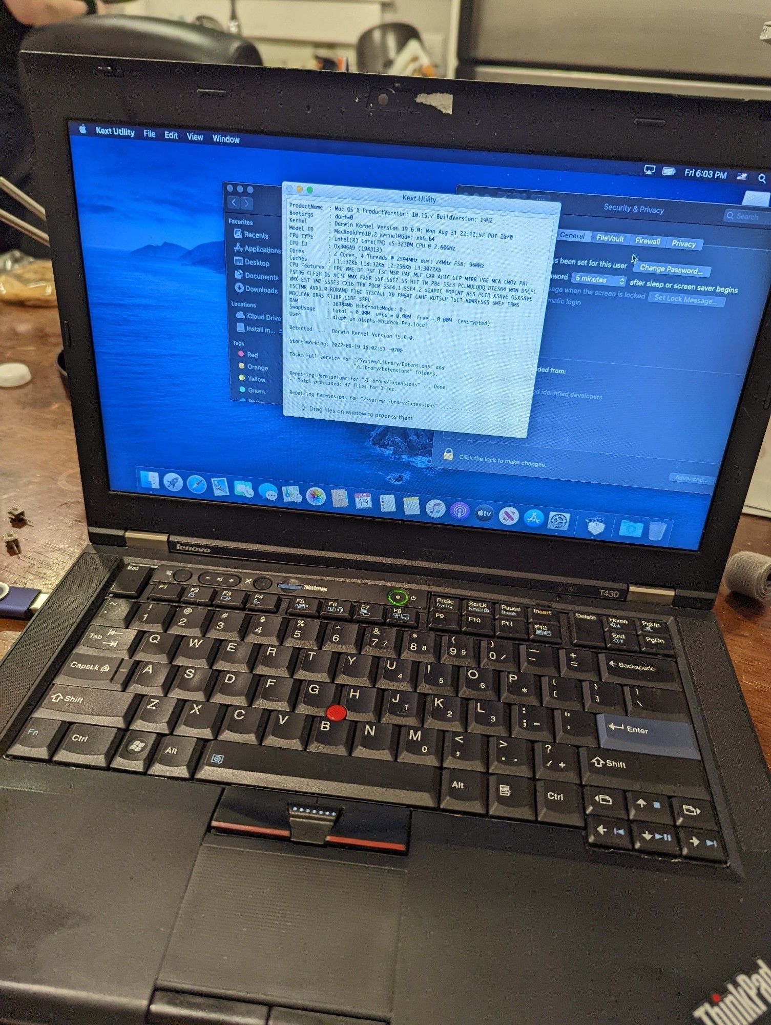 a thinkpad t480 on a table running MacOS Ventura, the screen showing a kernel extension manner which displays the specifications of the machine.