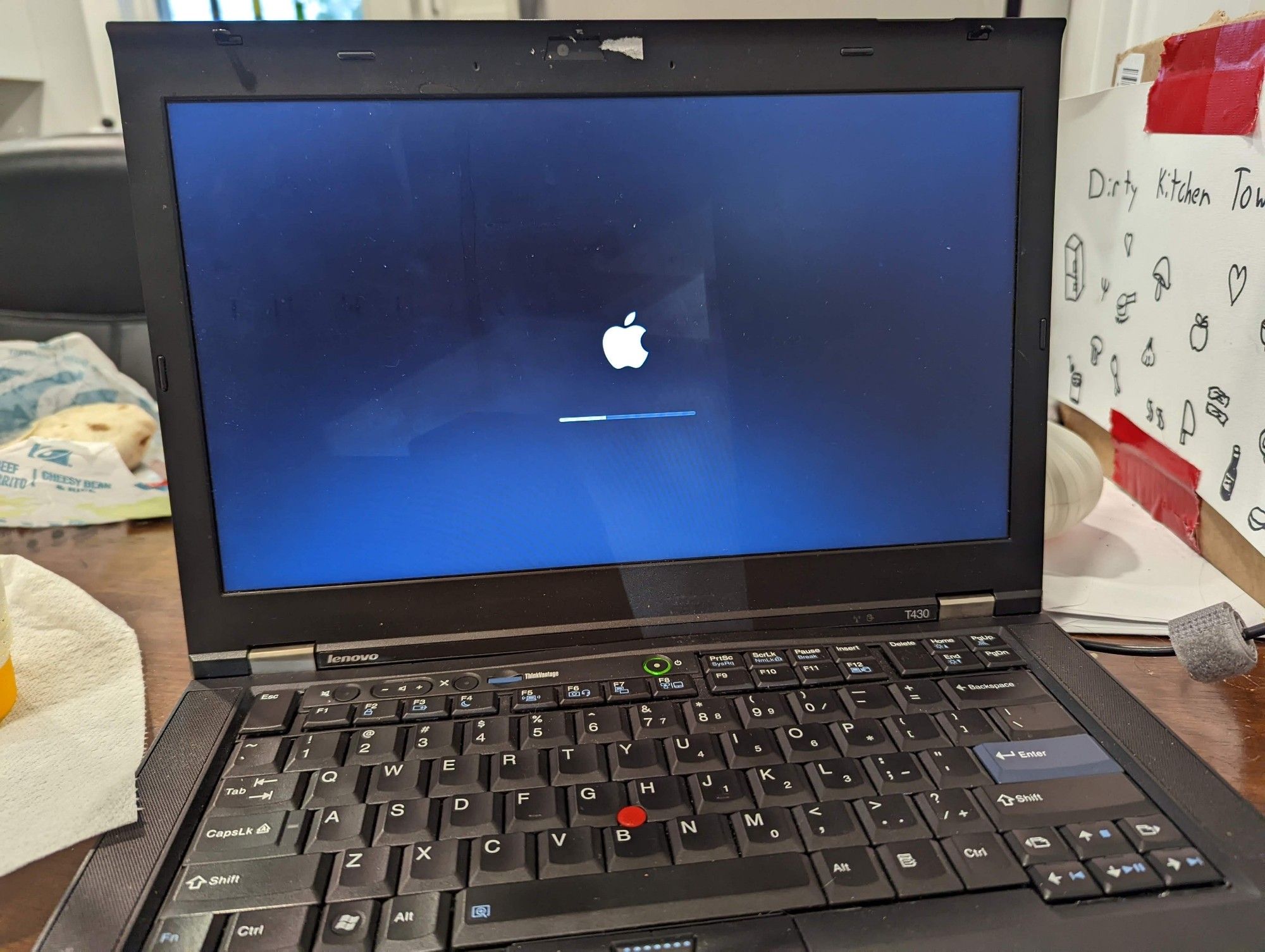 a thinkpad t480 booting into MacOS, with the Apple logo on its screen.