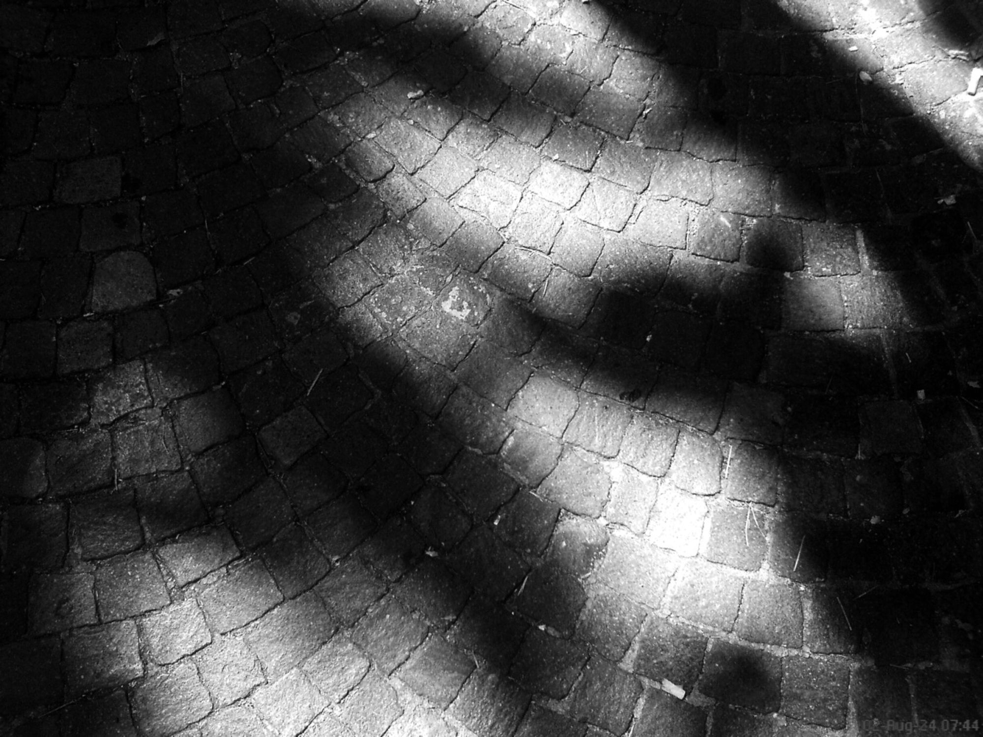 The streets of Rome - high-contrast light and shadow monochrome based on a photo from a 2006 Sony Ericsson W810i cell phone